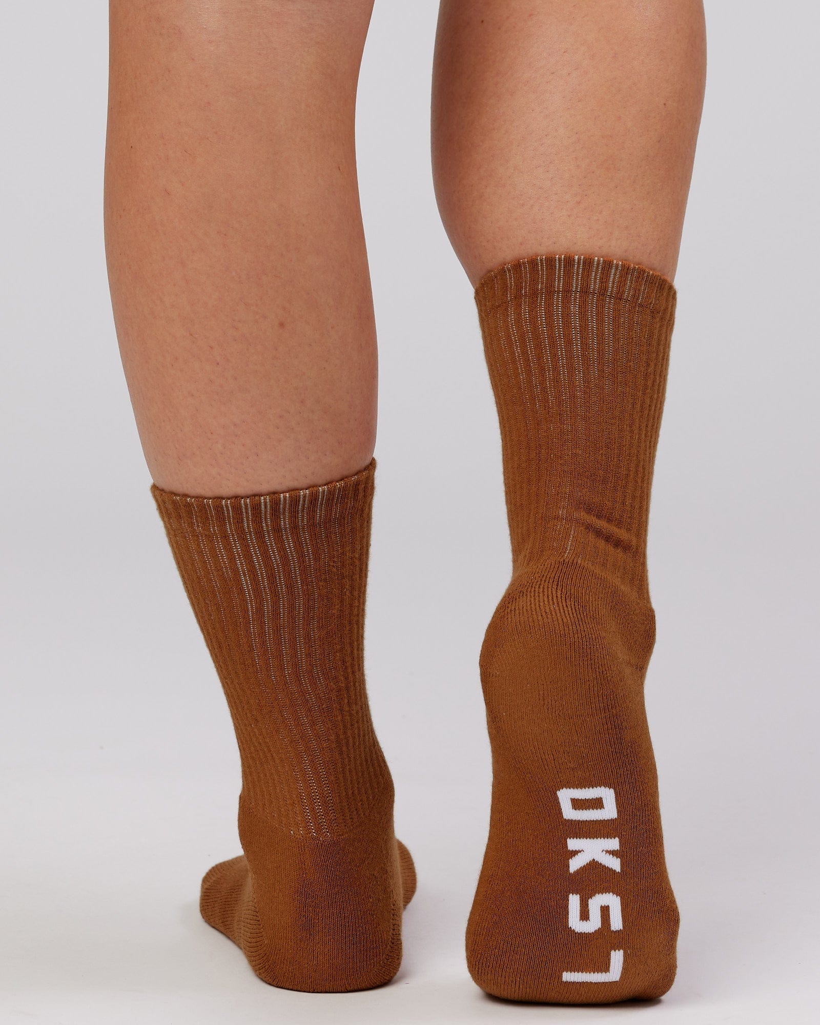 Model wearing Essential 3 Pack Crew Sock - Khaki/Cream/Red