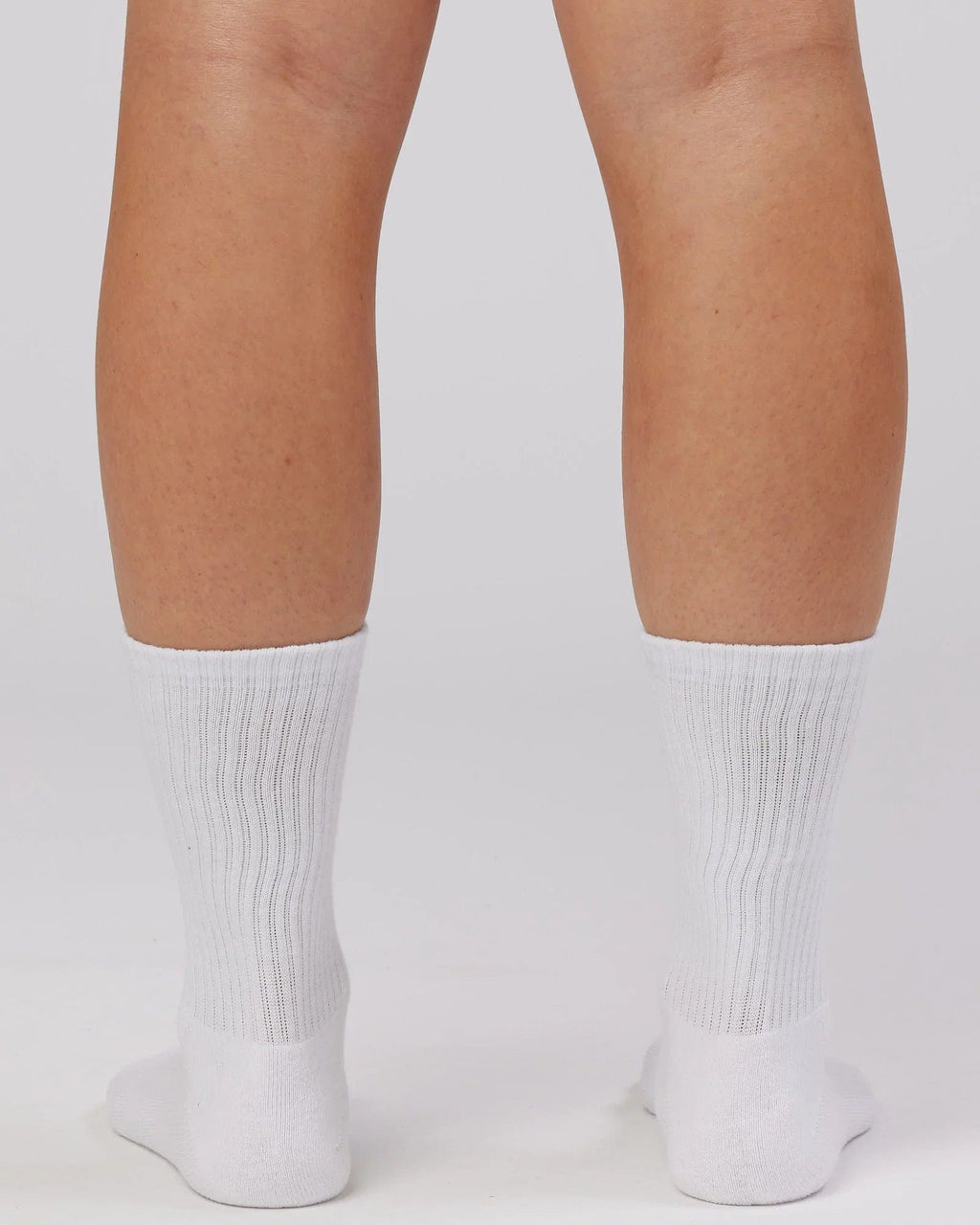 Model wearing Essential 3 Pack Crew Sock Gift - White