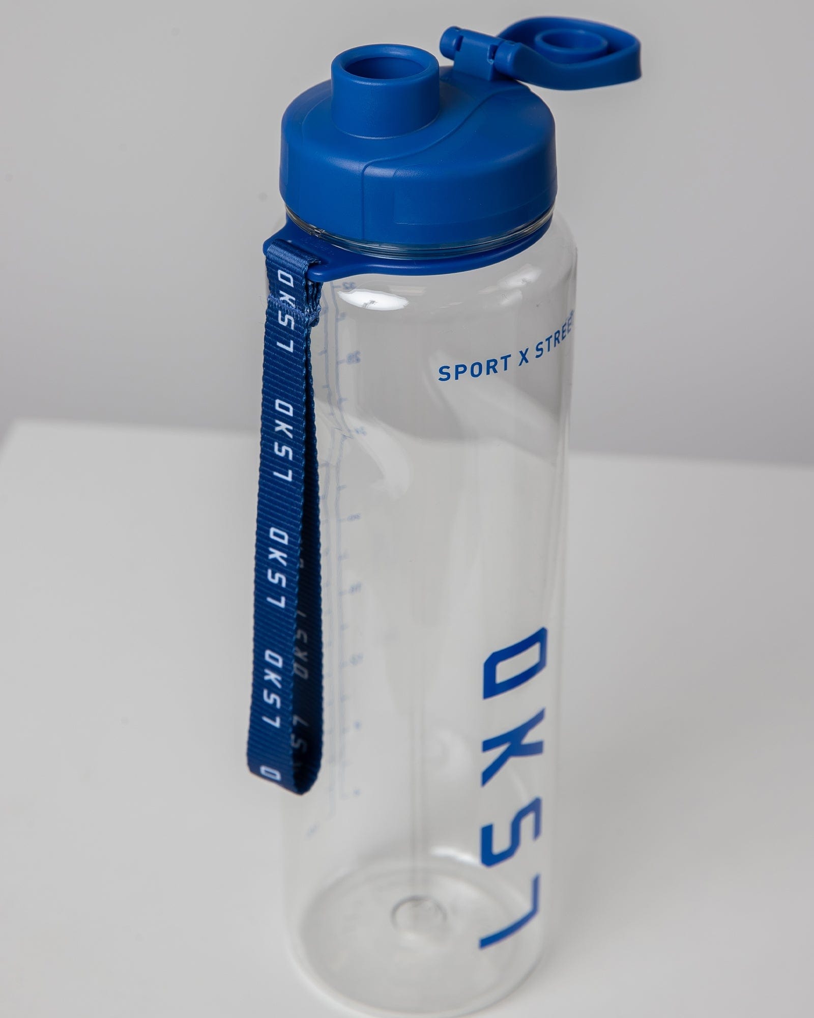 Model wearing Rep 1L Plastic Bottle - Turkish Sea-Clear
