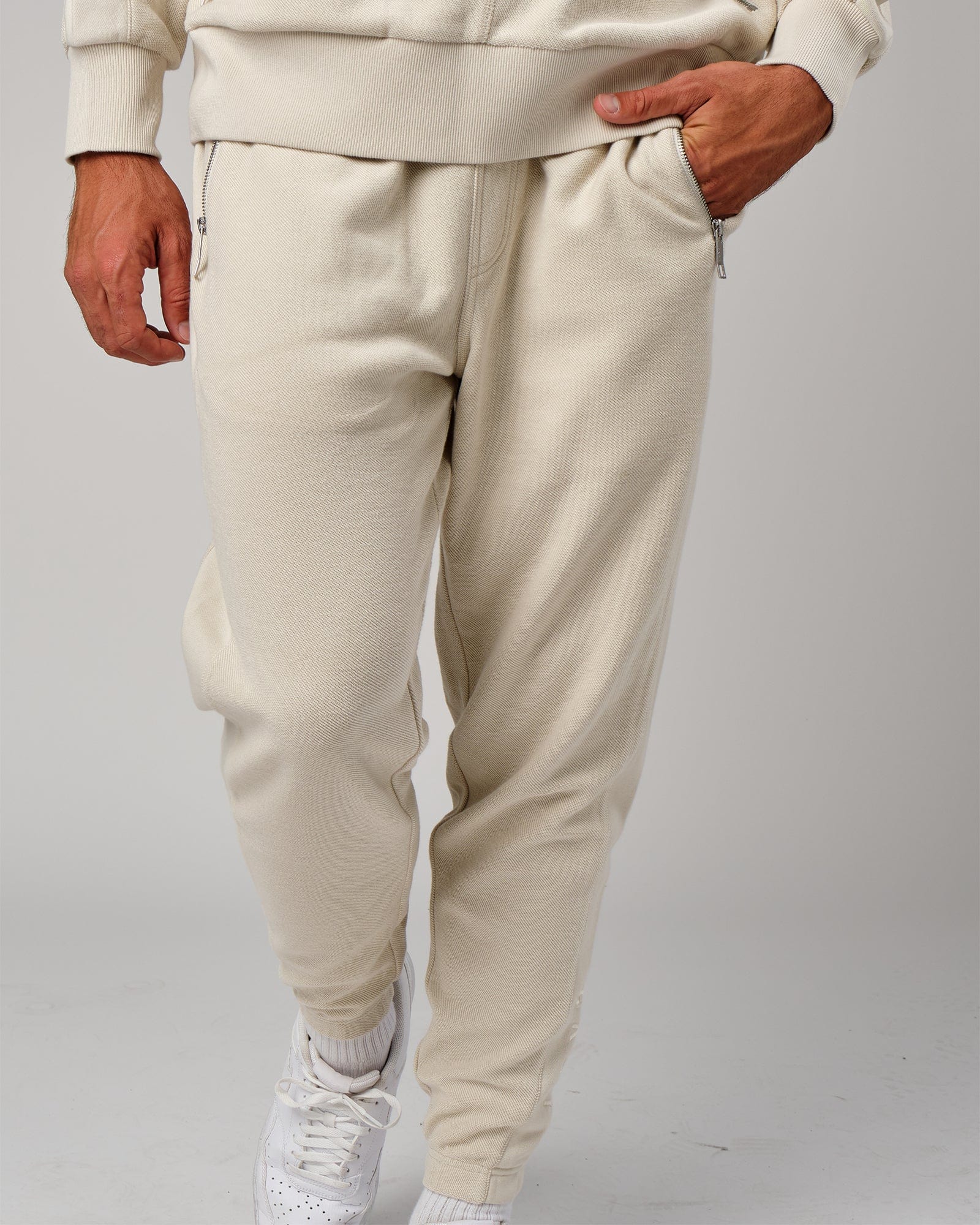 Model wearing Therma Track Pant - Bone