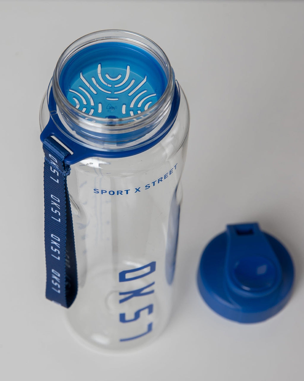 Model wearing Rep 1L Plastic Bottle - Turkish Sea-Clear