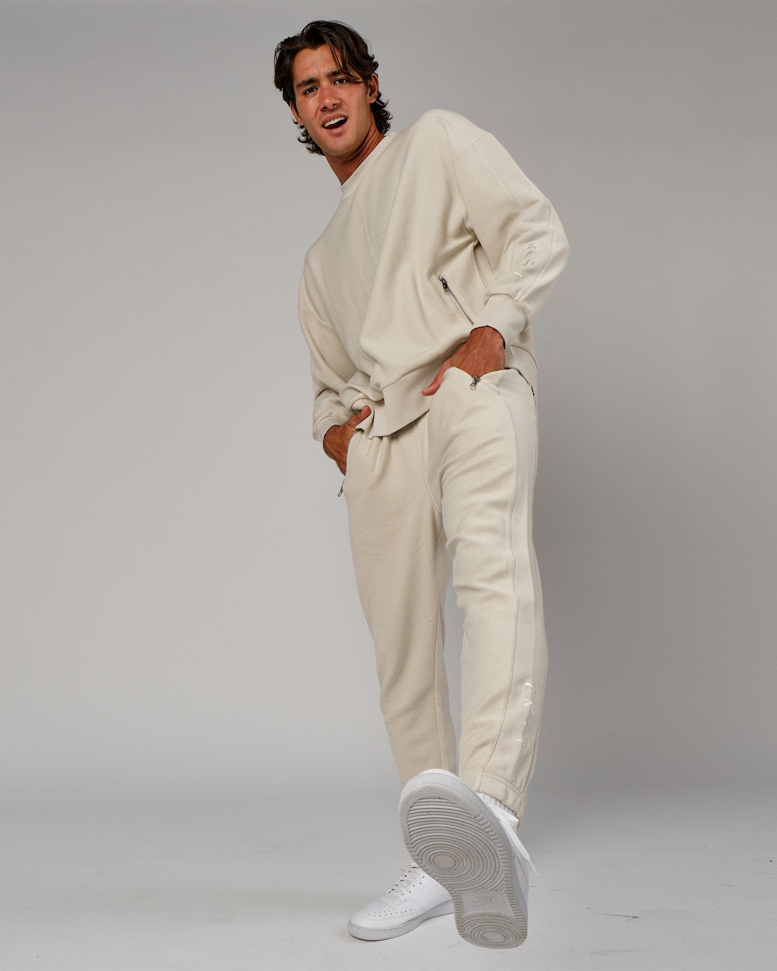 Model wearing Therma Track Pant - Bone