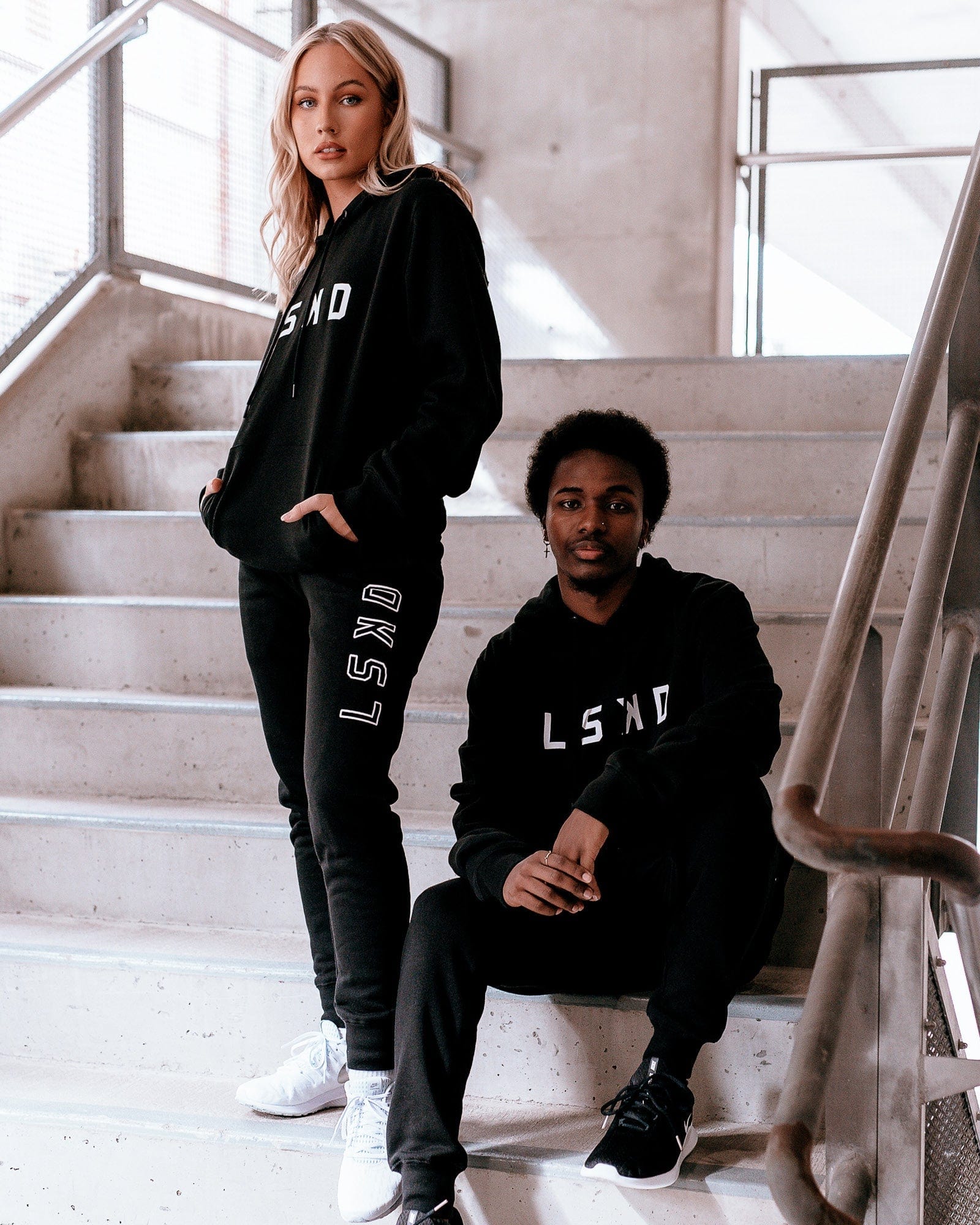 Model wearing Unisex Structure Hoodie - Black