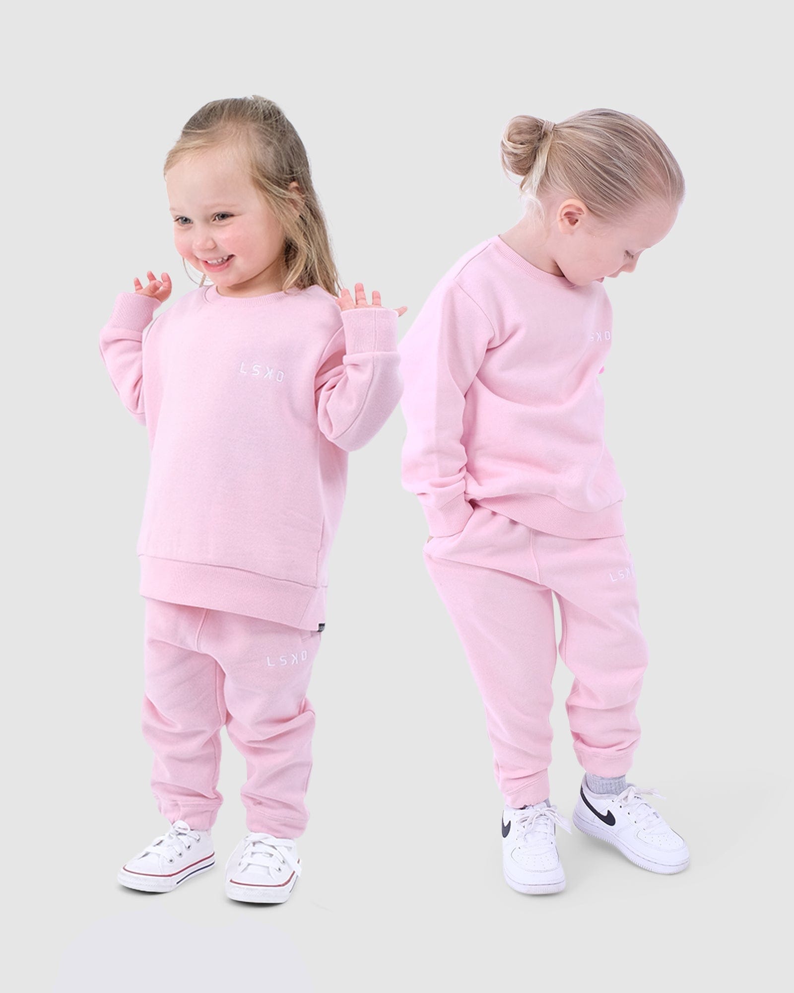 Model wearing Essential Track Pant (00-6) - Petal Pink