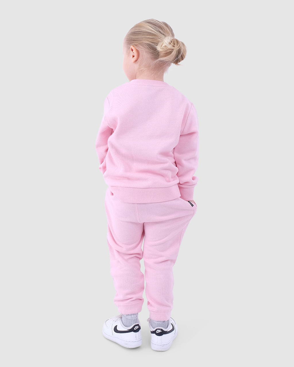 Model wearing Essential Track Pant (00-6) - Petal Pink