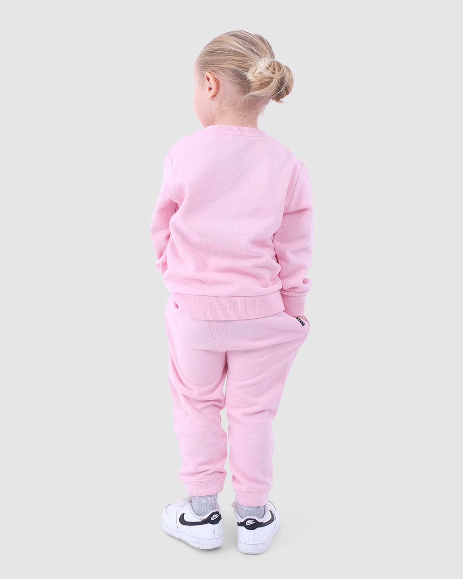 Model wearing Essential Track Pant (00-6) - Petal Pink