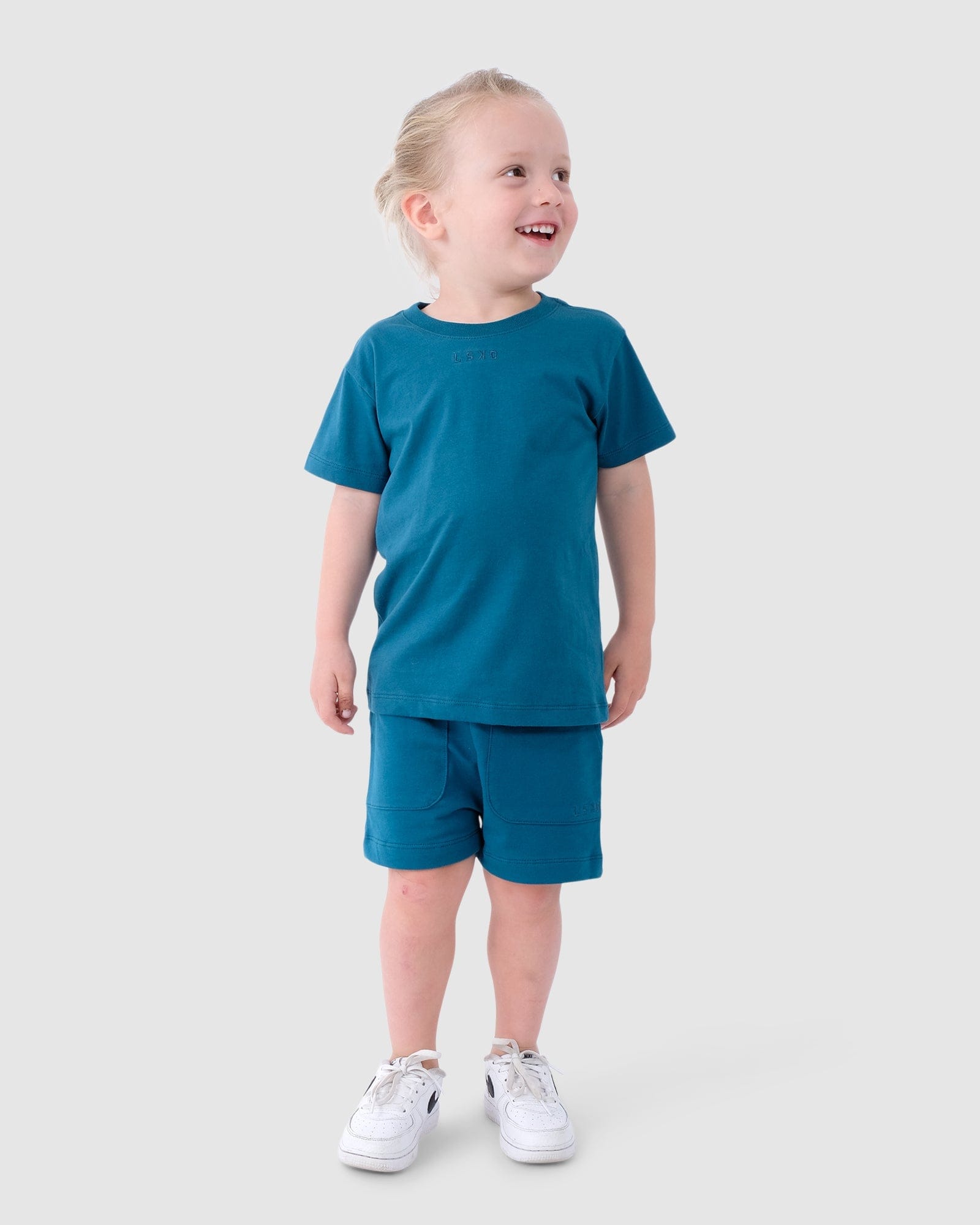 Model wearing Field Tee (00-8) - Blue Coral