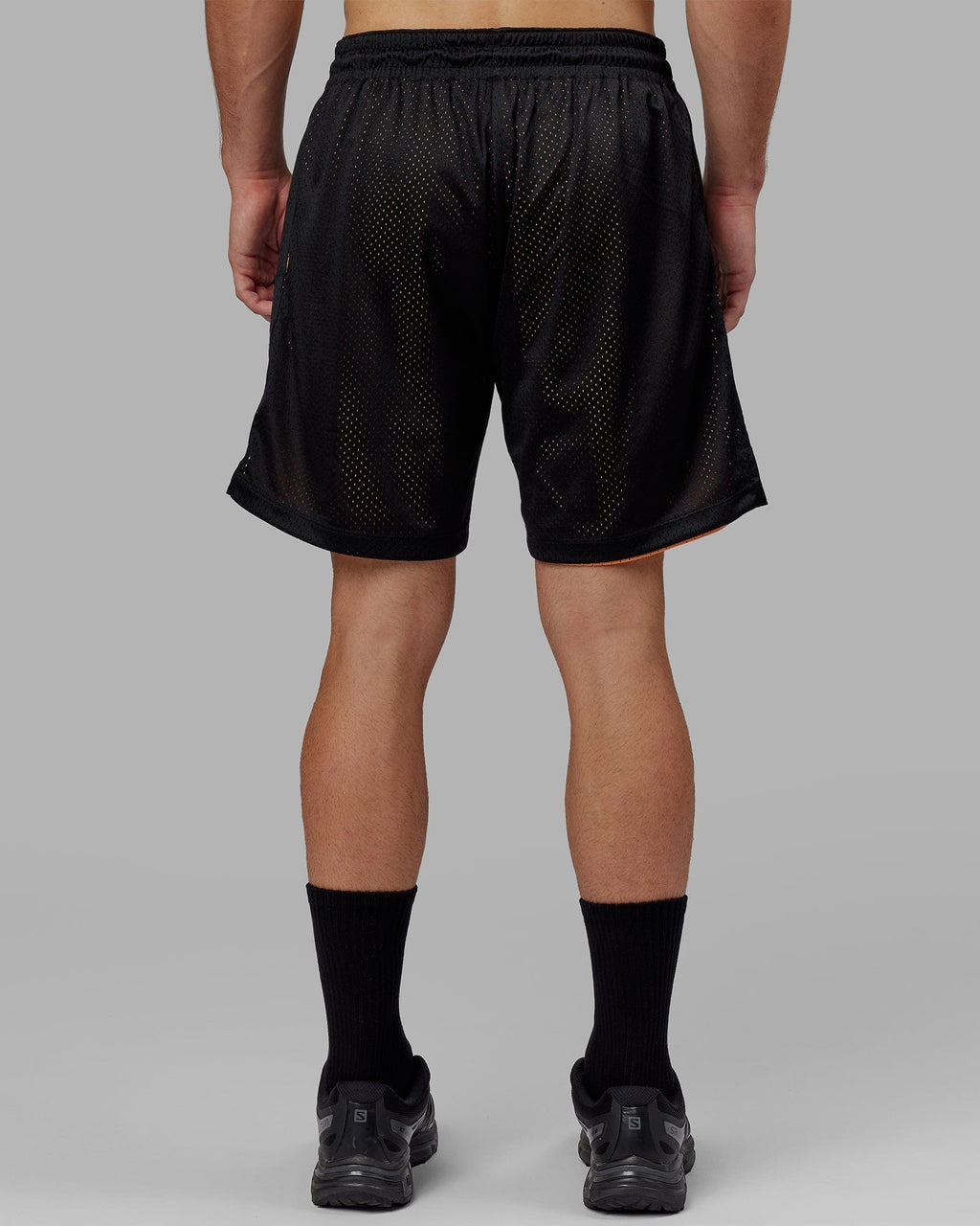 Model wearing Hyper Reversible Basketball Short - Black-Tangerine