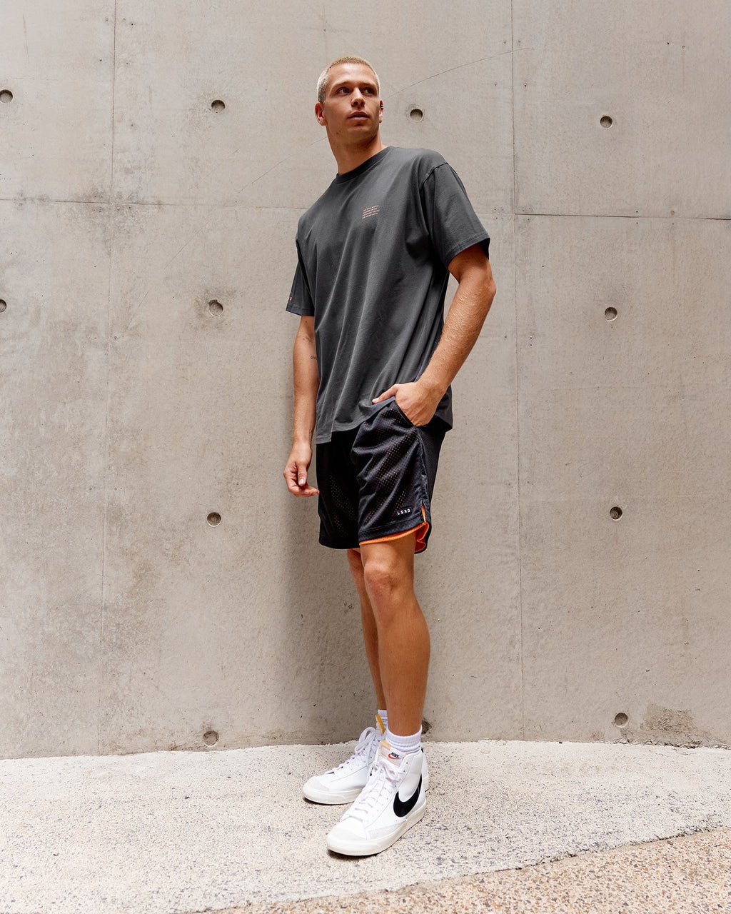Model wearing Hyper Reversible Basketball Short - Black-Tangerine