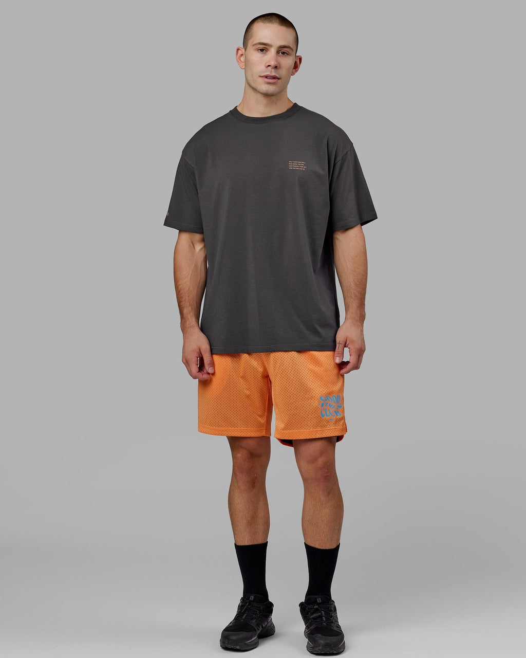 Model wearing Hyper Reversible Basketball Short - Black-Tangerine