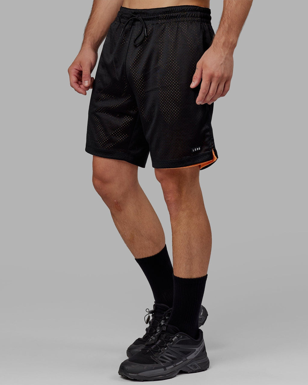Model wearing Hyper Reversible Basketball Short - Black-Tangerine