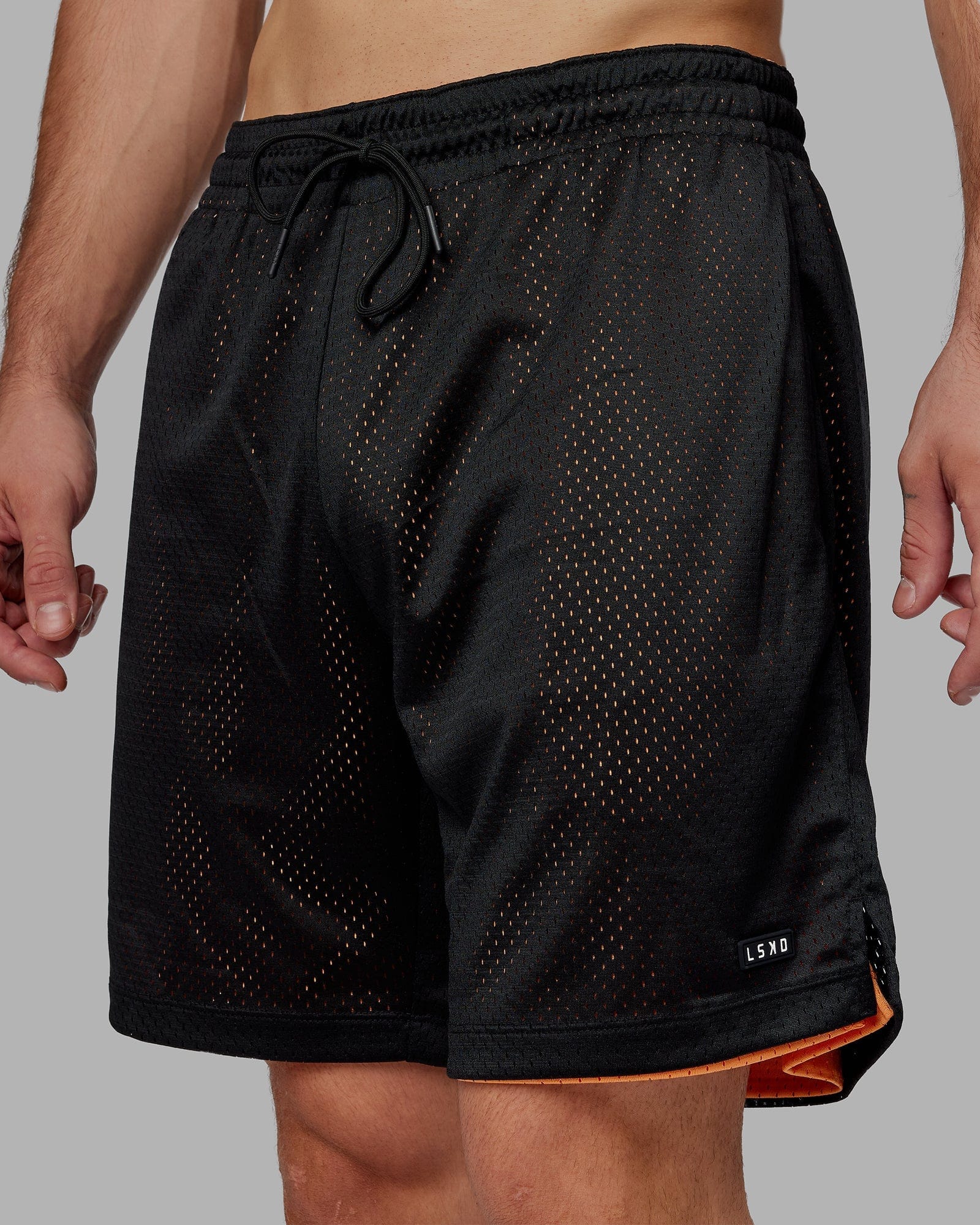 Model wearing Hyper Reversible Basketball Short - Black-Tangerine