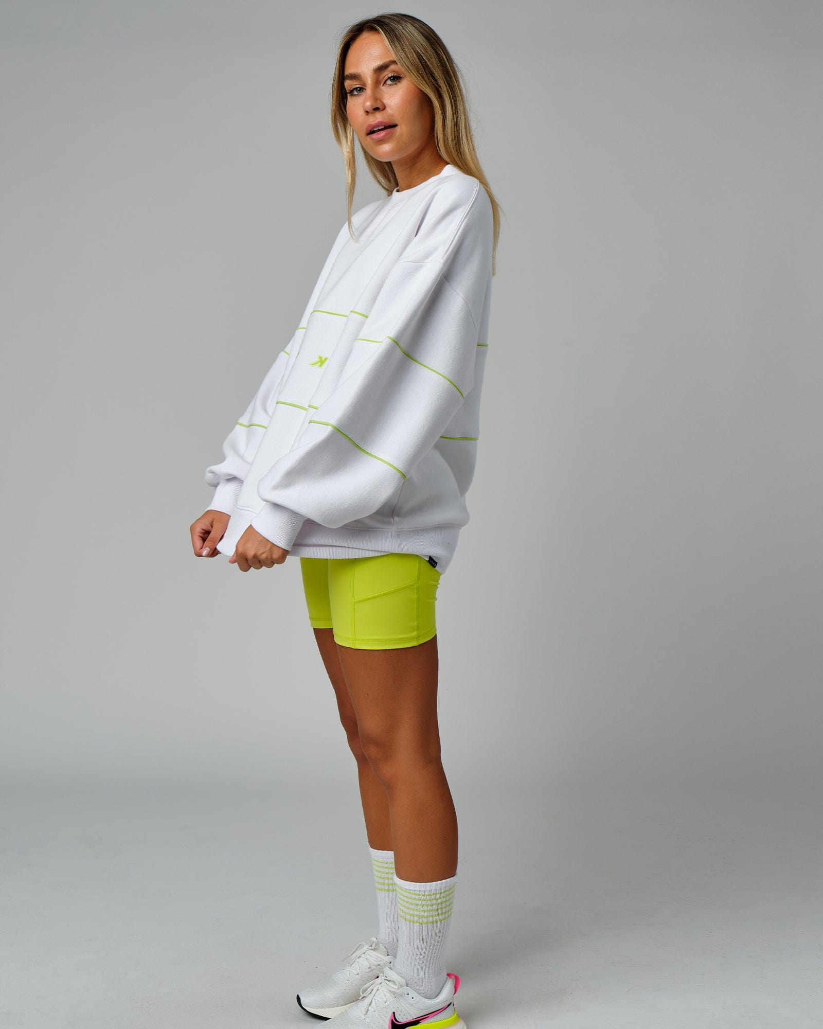 Model wearing Unisex Ascent Oversized Sweater - White-Fluro Lime