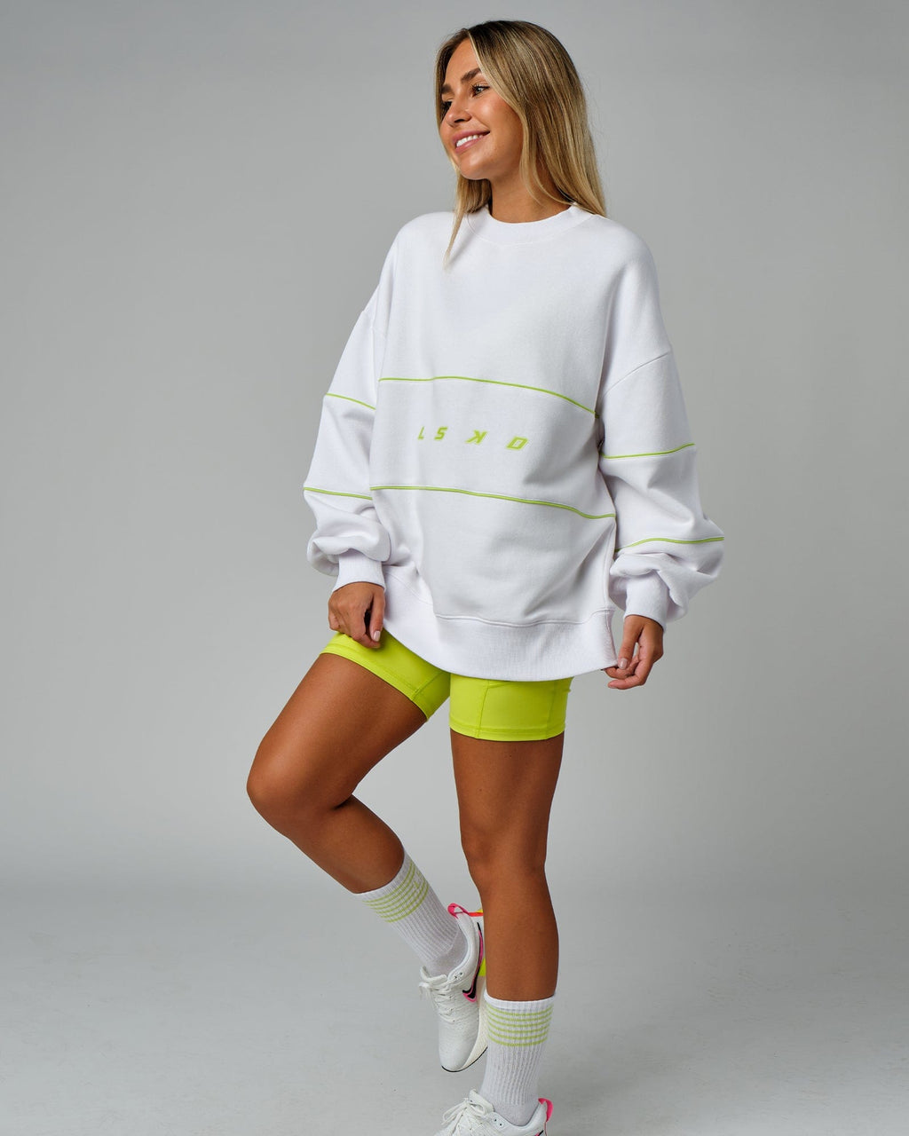 Model wearing Unisex Ascent Oversized Sweater - White-Fluro Lime