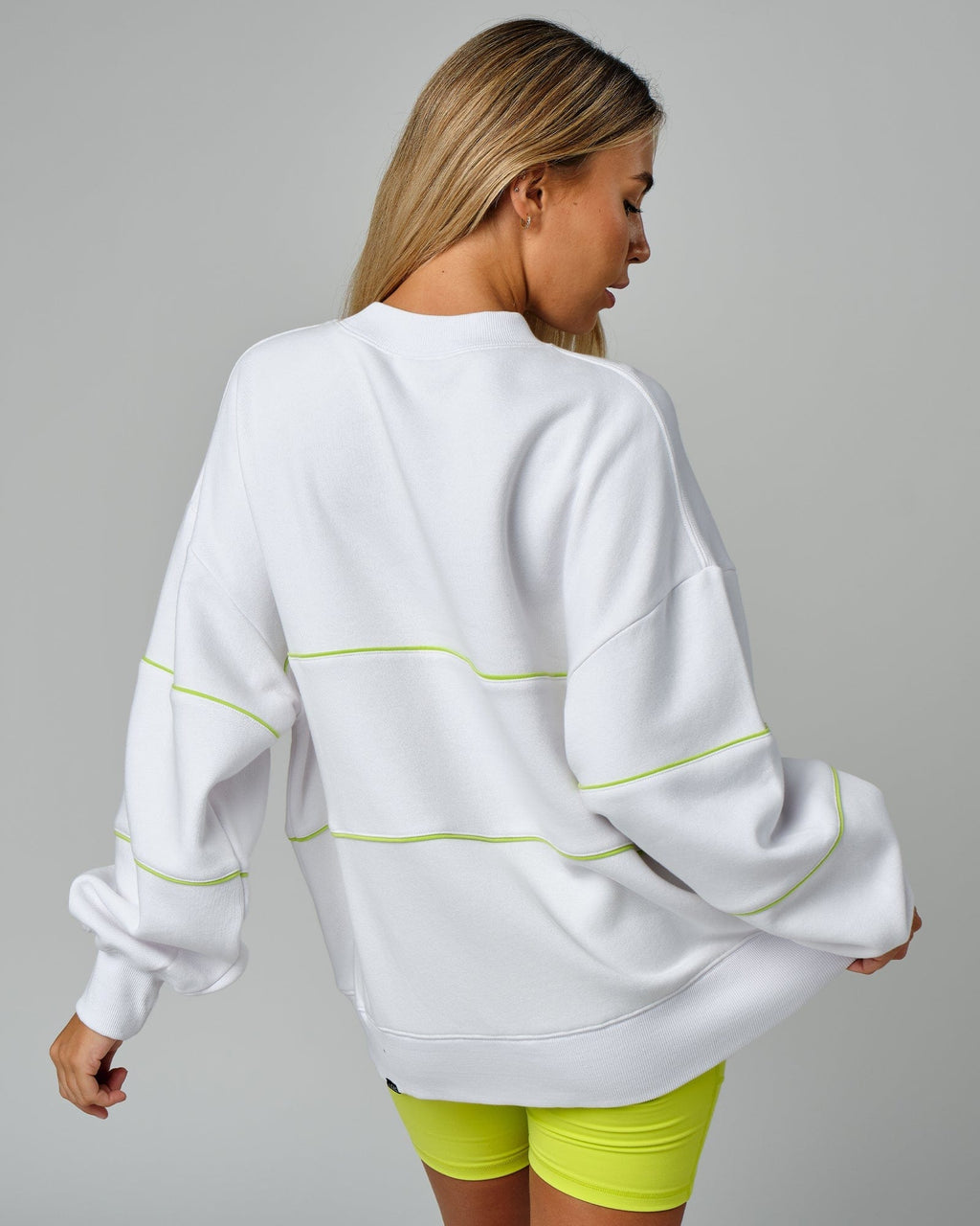 Model wearing Unisex Ascent Oversized Sweater - White-Fluro Lime
