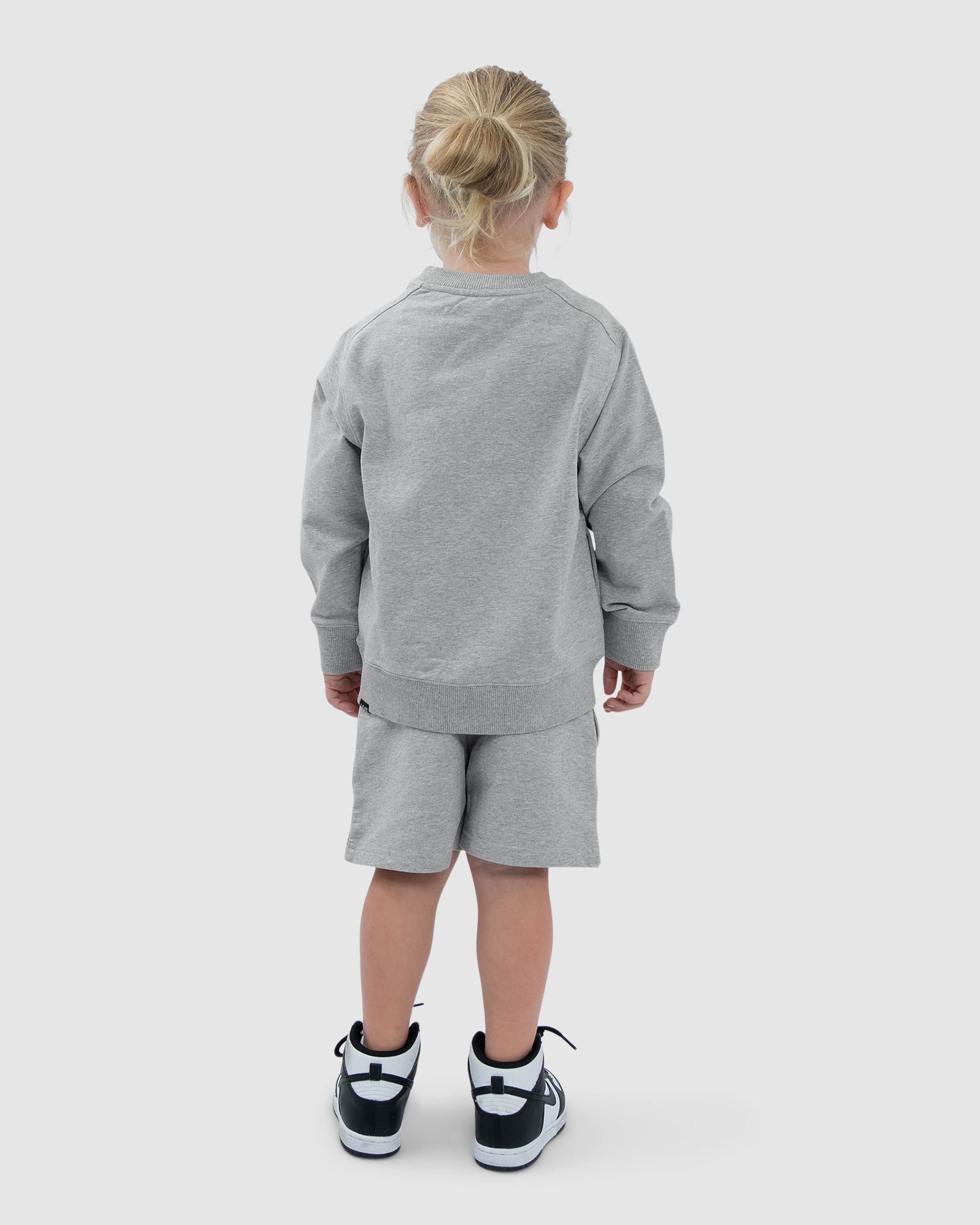 Model wearing Routine Sweater (00-8) - Lt Grey Marl