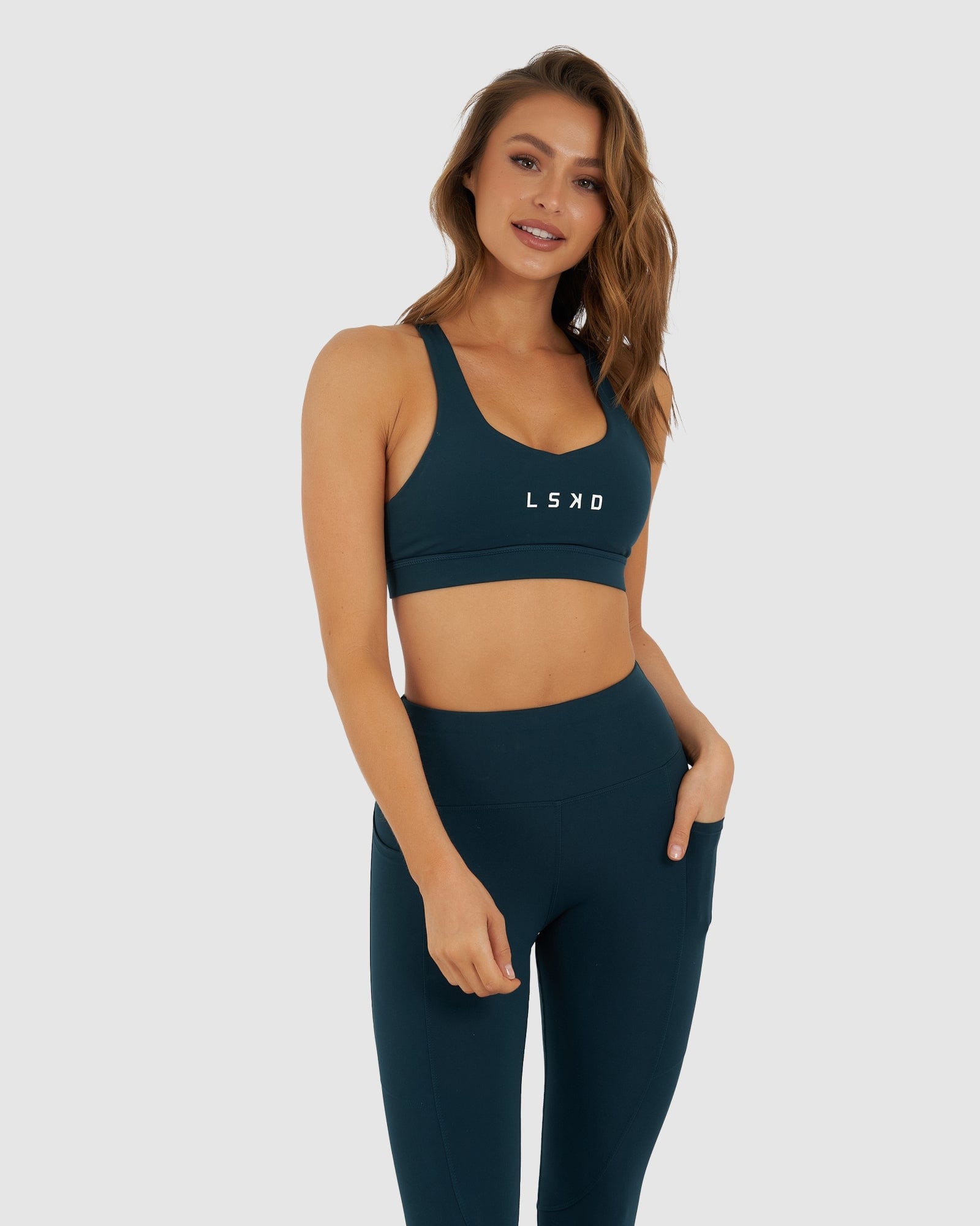 Model wearing Rep Sports Bra Small Logo - Deep Teal