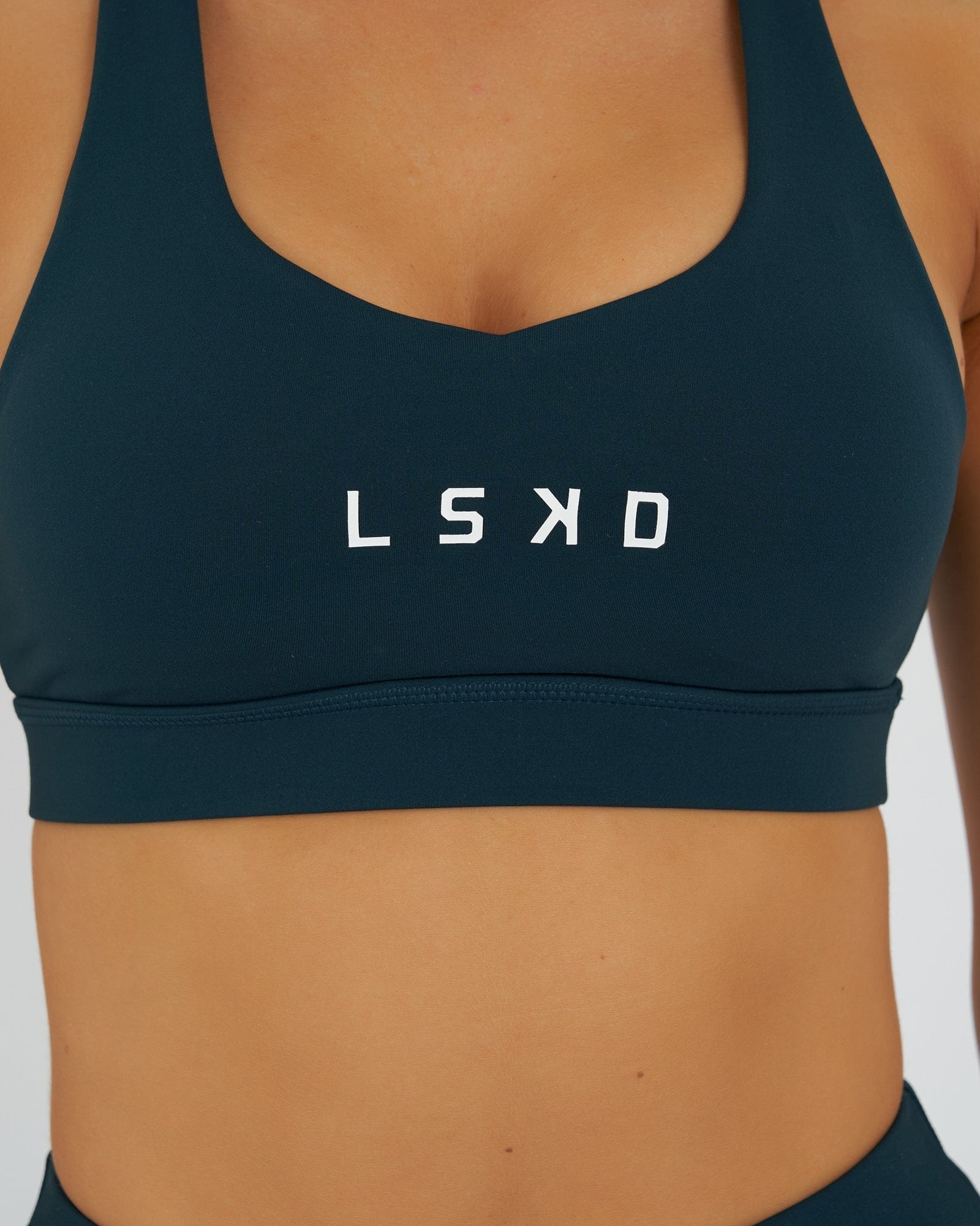 Model wearing Rep Sports Bra Small Logo - Deep Teal