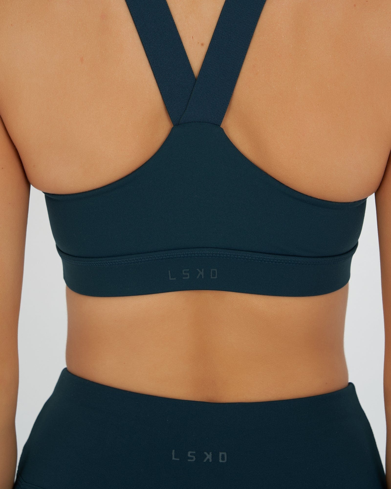 Model wearing Rep Sports Bra Small Logo - Deep Teal