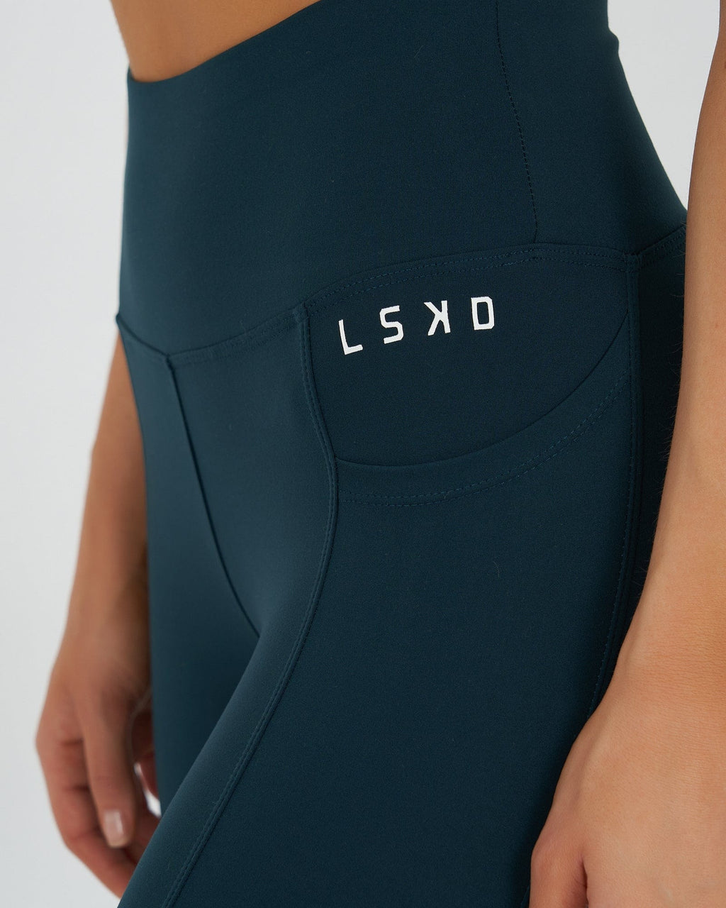 Model wearing Rep 7/8 Length Tight Small Logo - Deep Teal