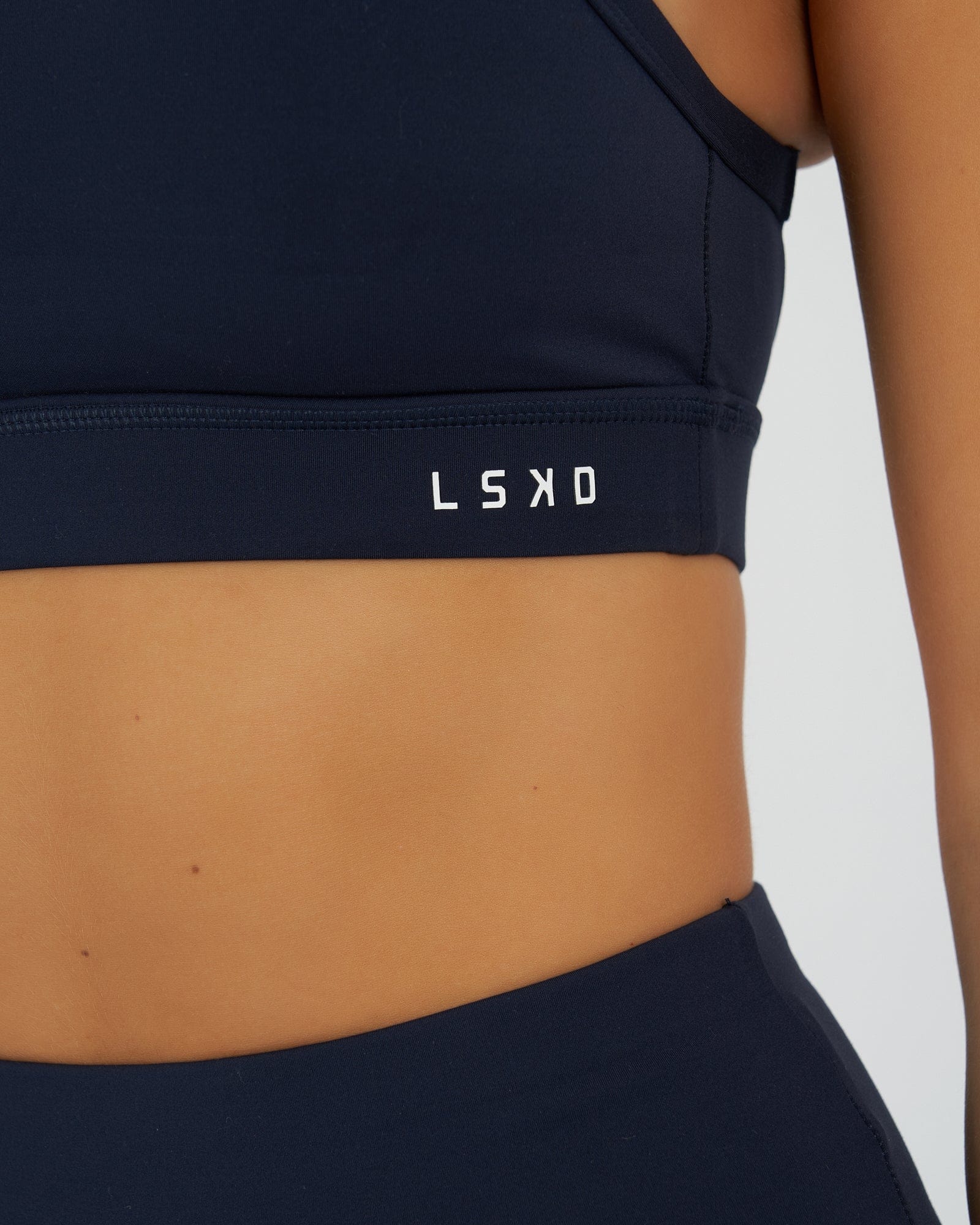 Model wearing Momentum Sports Bra - Navy