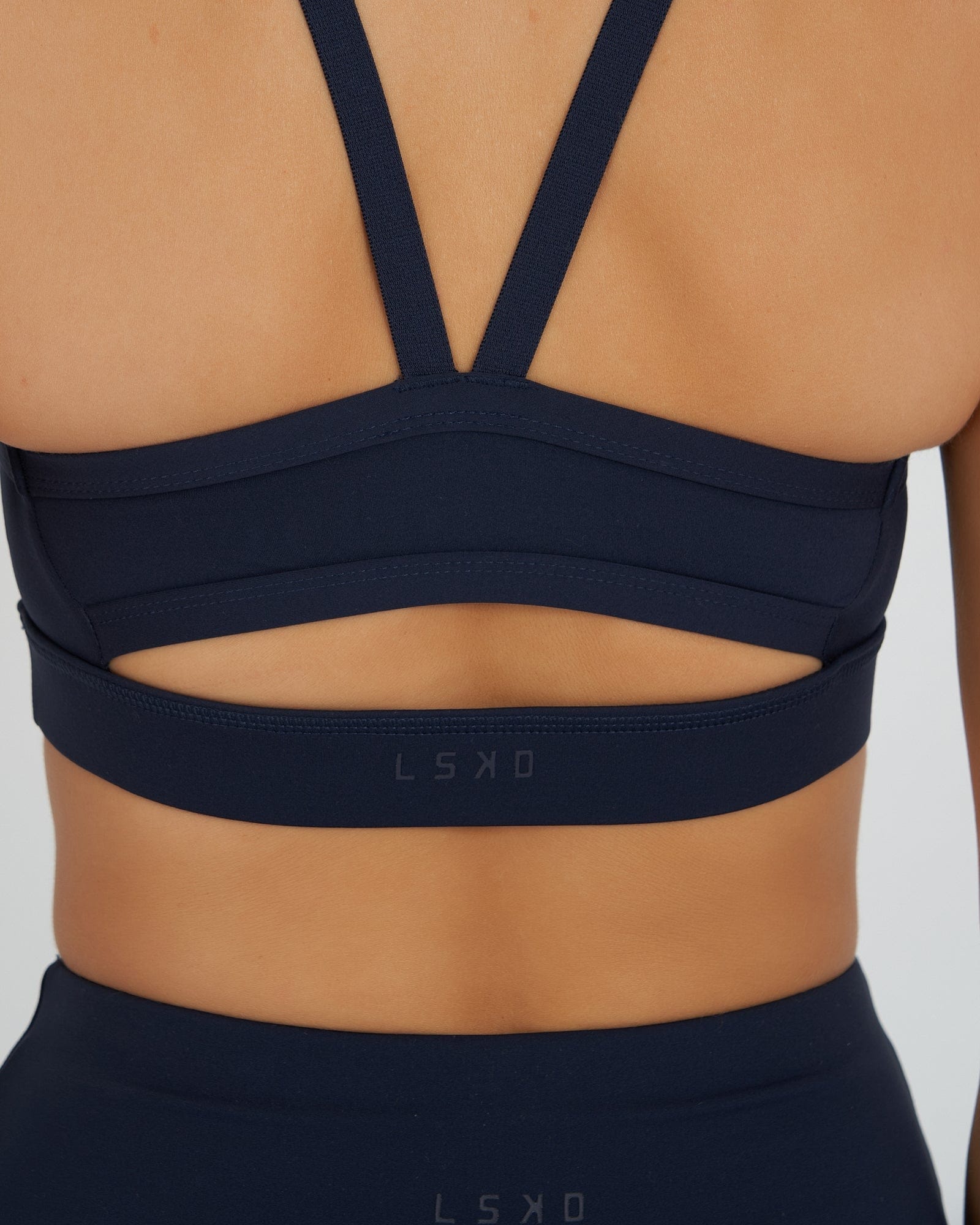 Model wearing Momentum Sports Bra - Navy