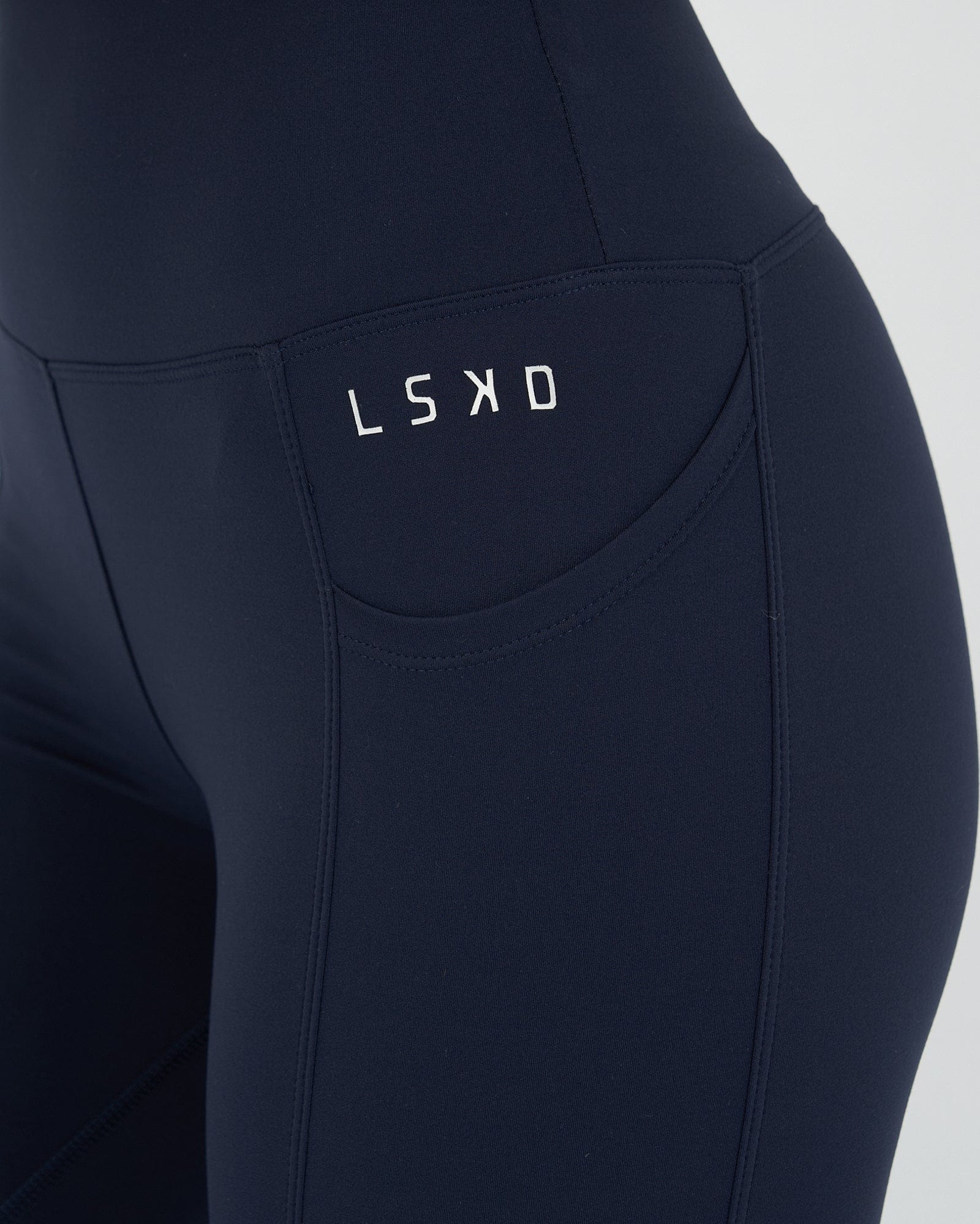 Model wearing Rep 7/8 Length Tight Small Logo - Navy