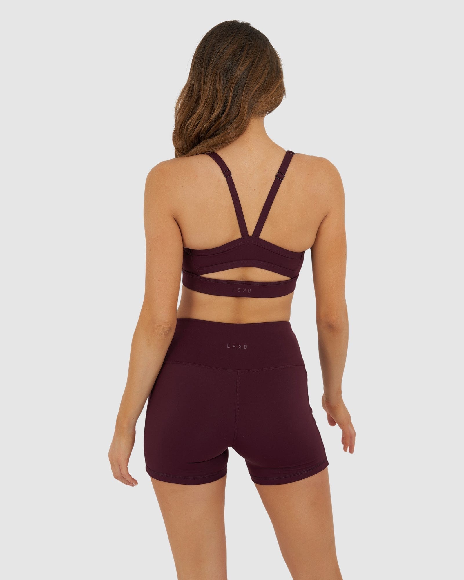 Model wearing Momentum Sports Bra - Wine