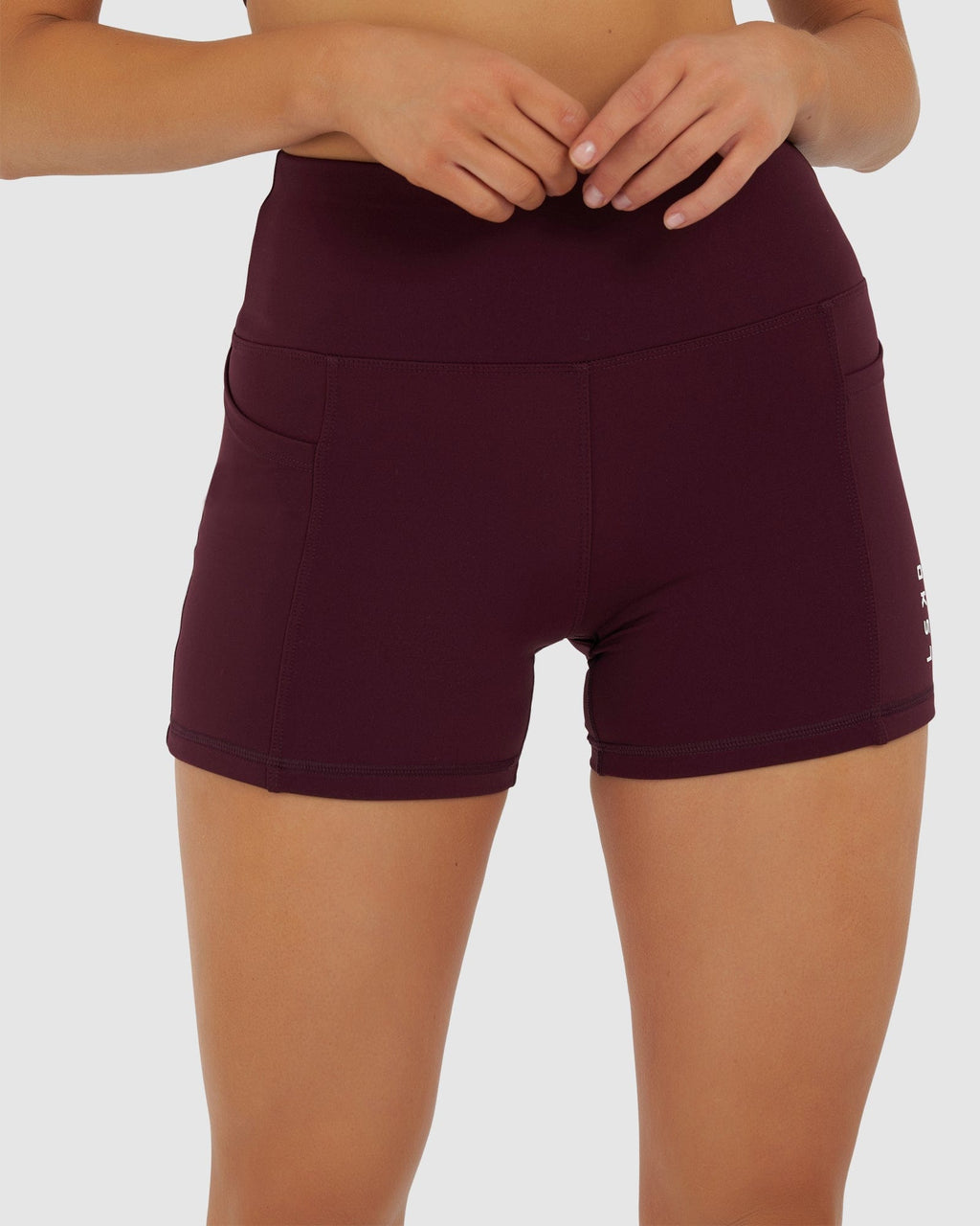 Model wearing Rep X-Short Tight Small Logo - Wine