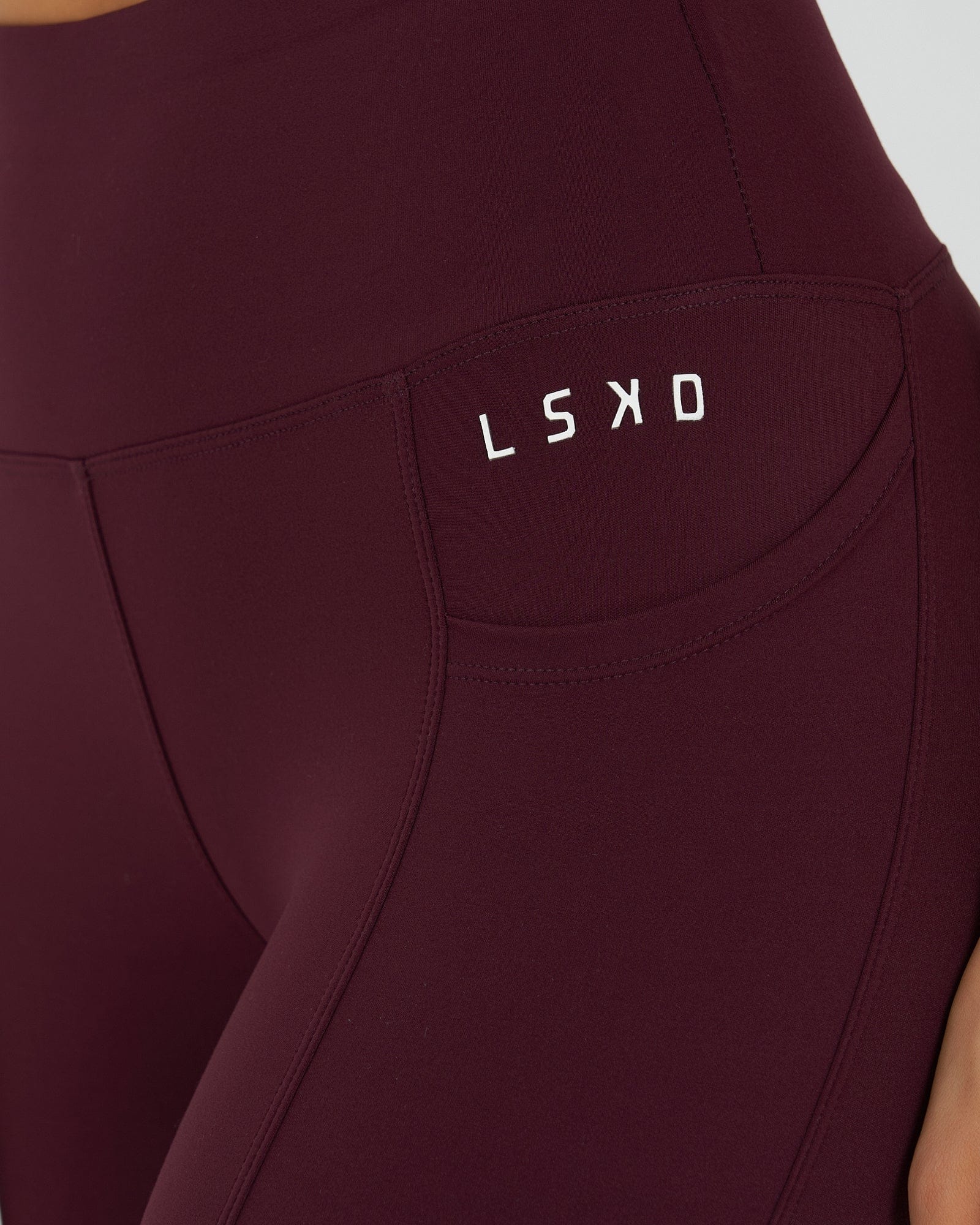 Model wearing Rep 7/8 Length Tight Small Logo - Wine