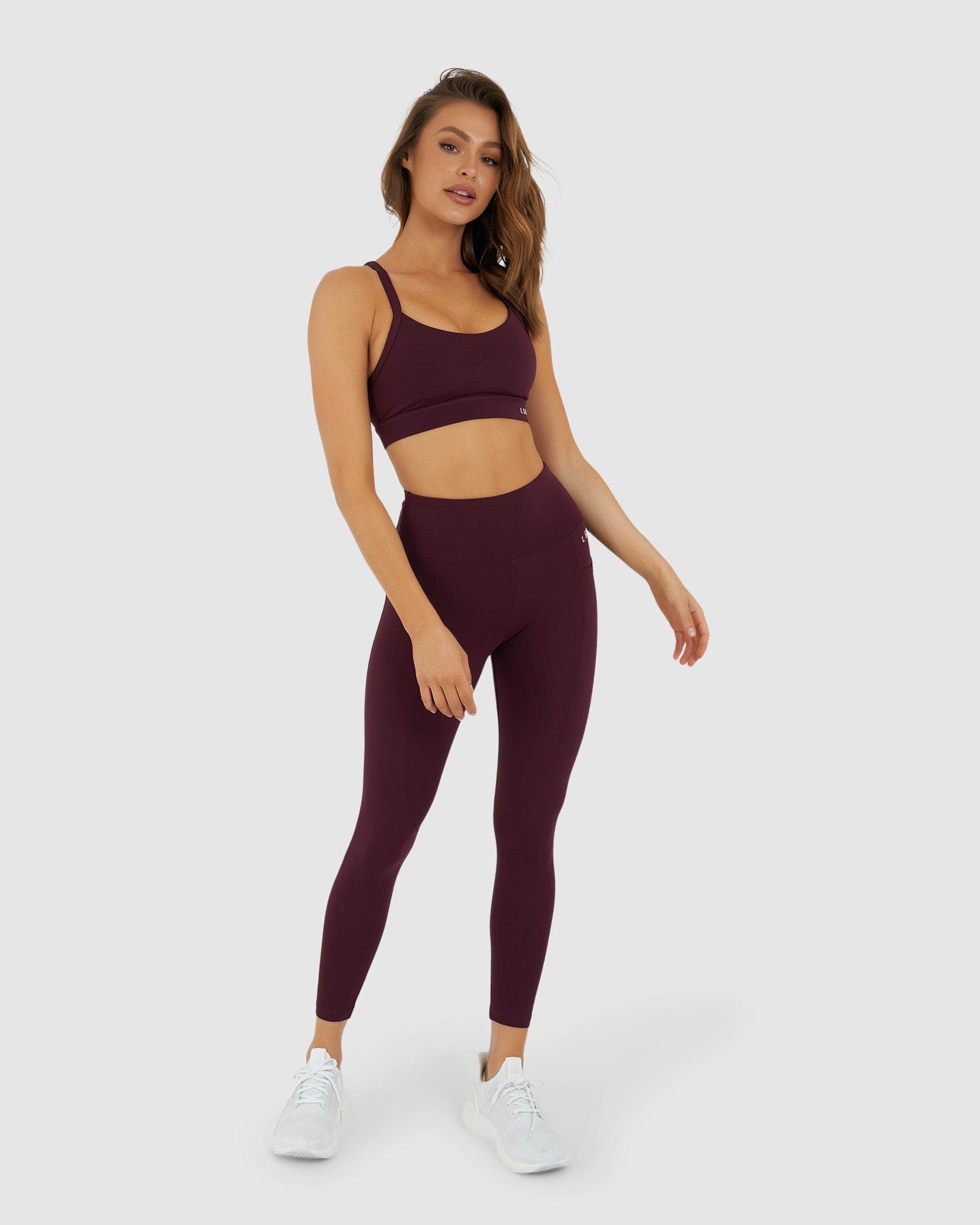 Model wearing Rep 7/8 Length Tight Small Logo - Wine