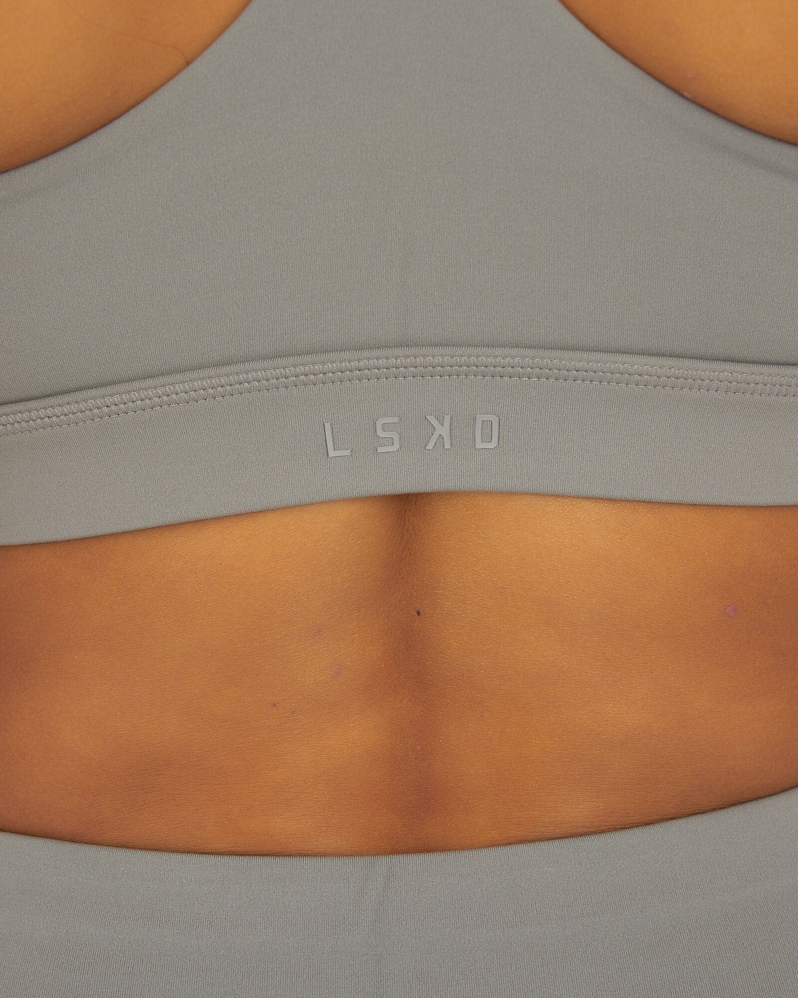 Model wearing Rep Sports Bra Small Logo - Frost Grey