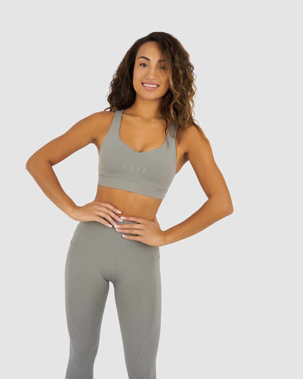 Model wearing Rep Sports Bra Small Logo - Frost Grey