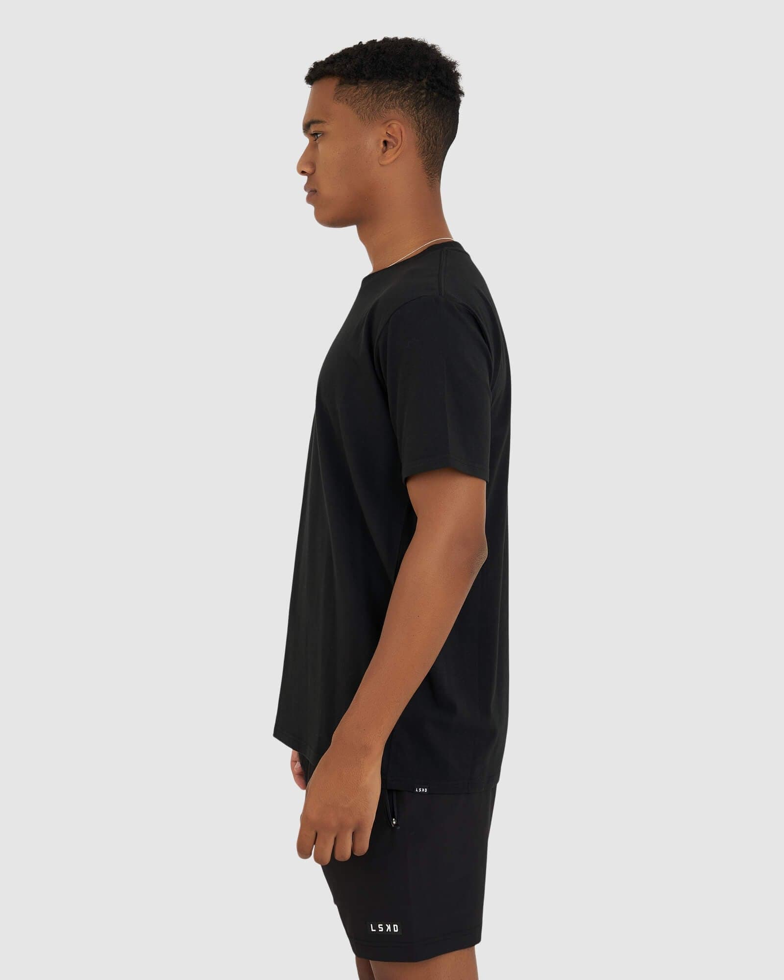 Model wearing Base Tee - Black