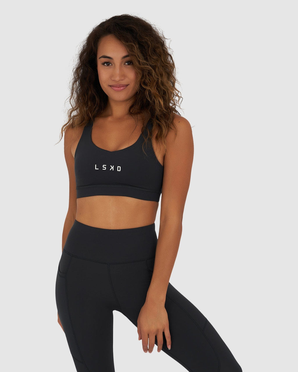 Model wearing Rep Sports Bra Small Logo - Midnight