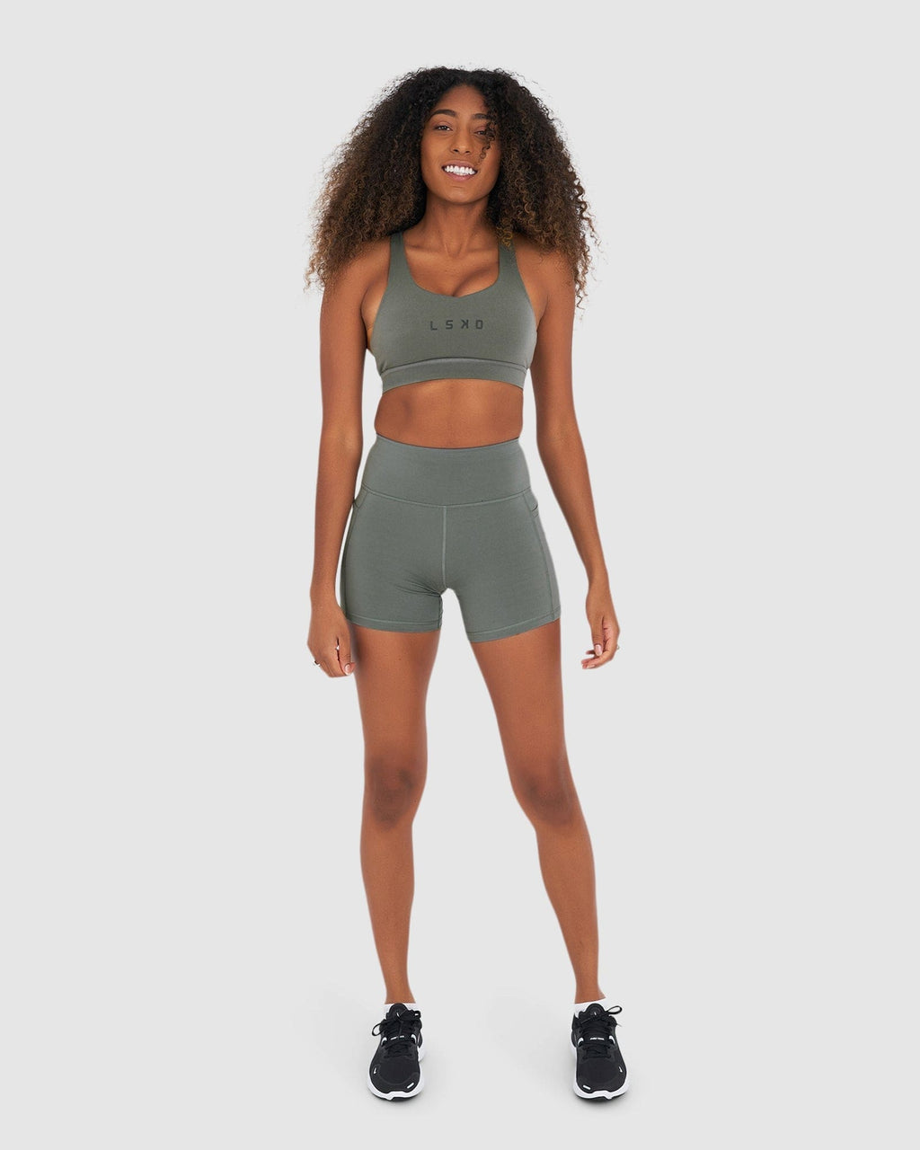 Model wearing Rep X-Short Tight Small Logo - Graphite