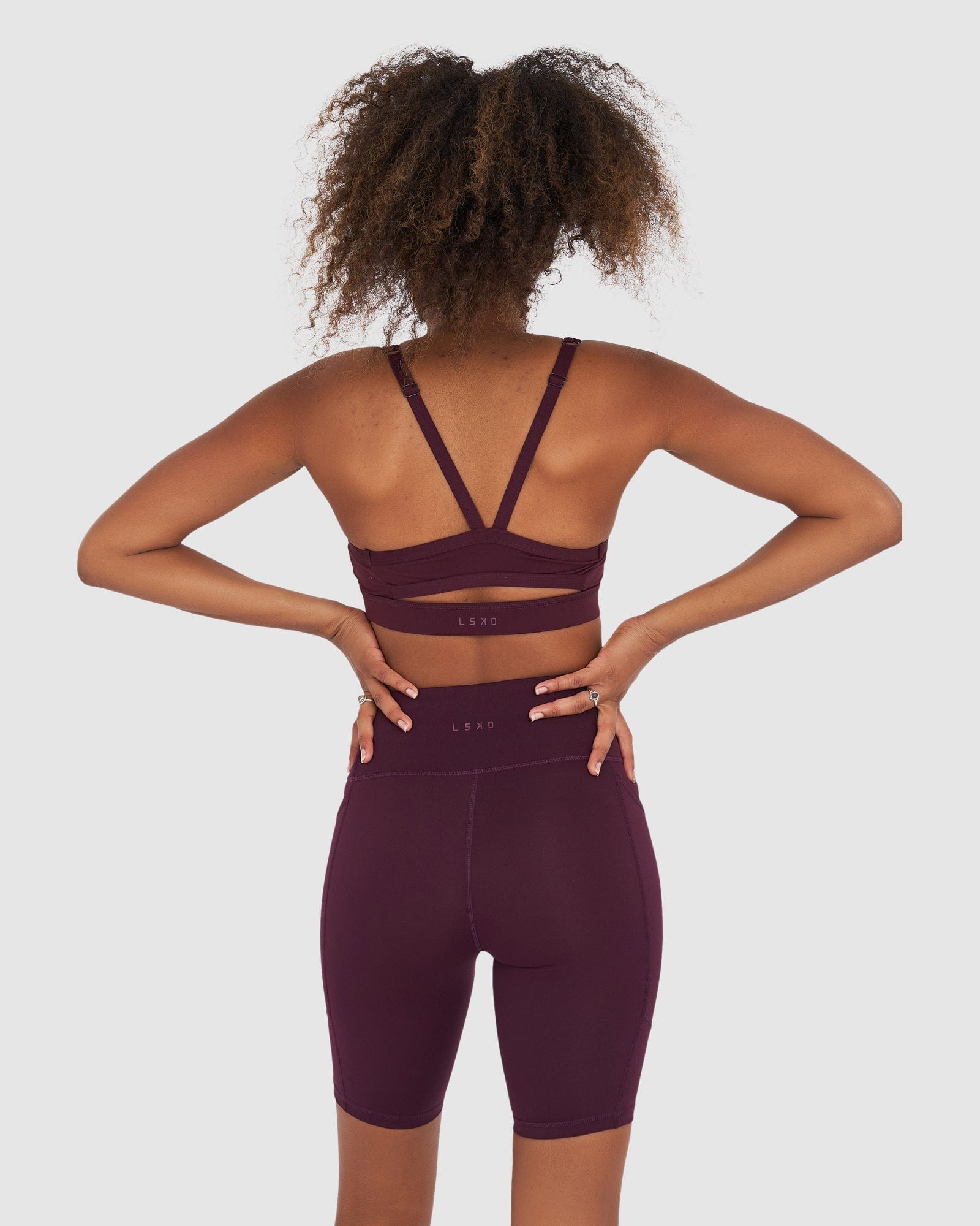 Model wearing Rep Short Tight Small Logo - Wine