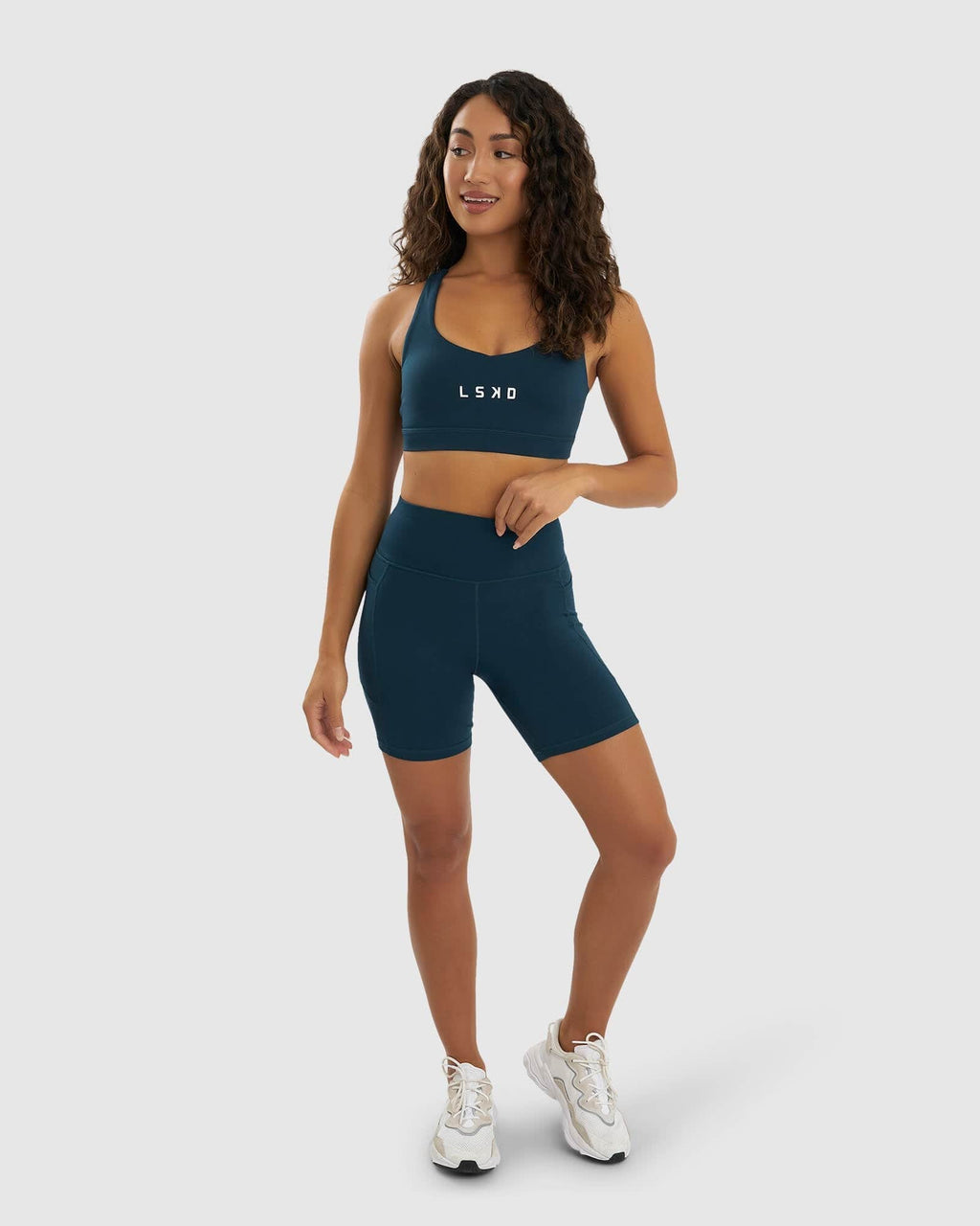 Model wearing Rep Mid Short Tight Small Logo - Deep Teal