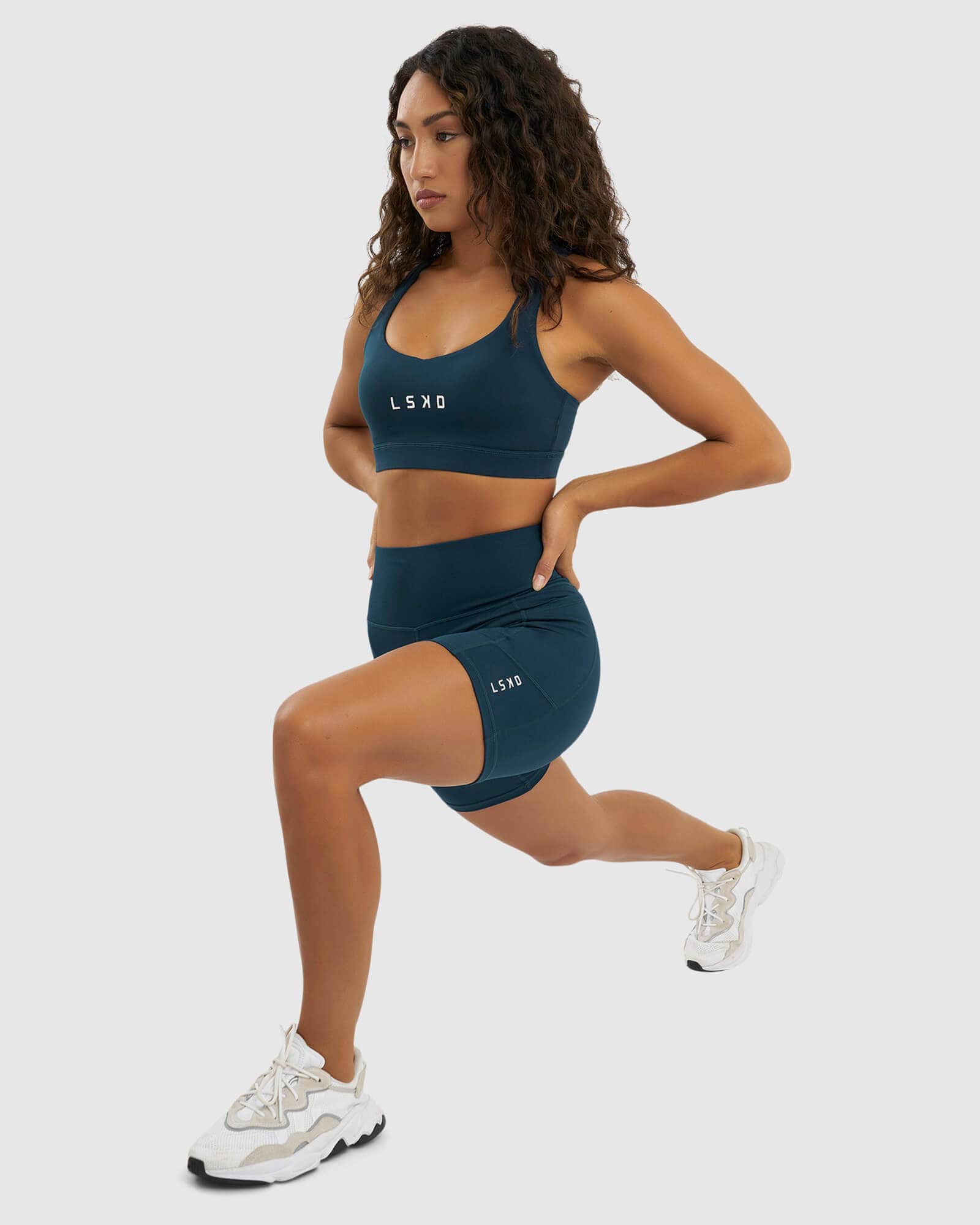 Model wearing Rep Mid Short Tight Small Logo - Deep Teal