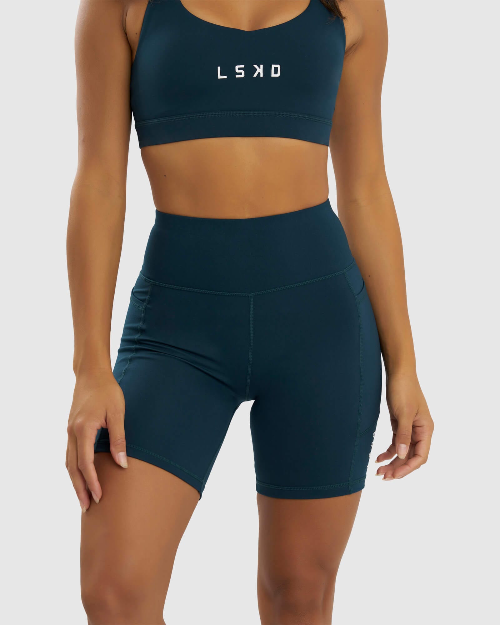 Model wearing Rep Mid Short Tight Small Logo - Deep Teal