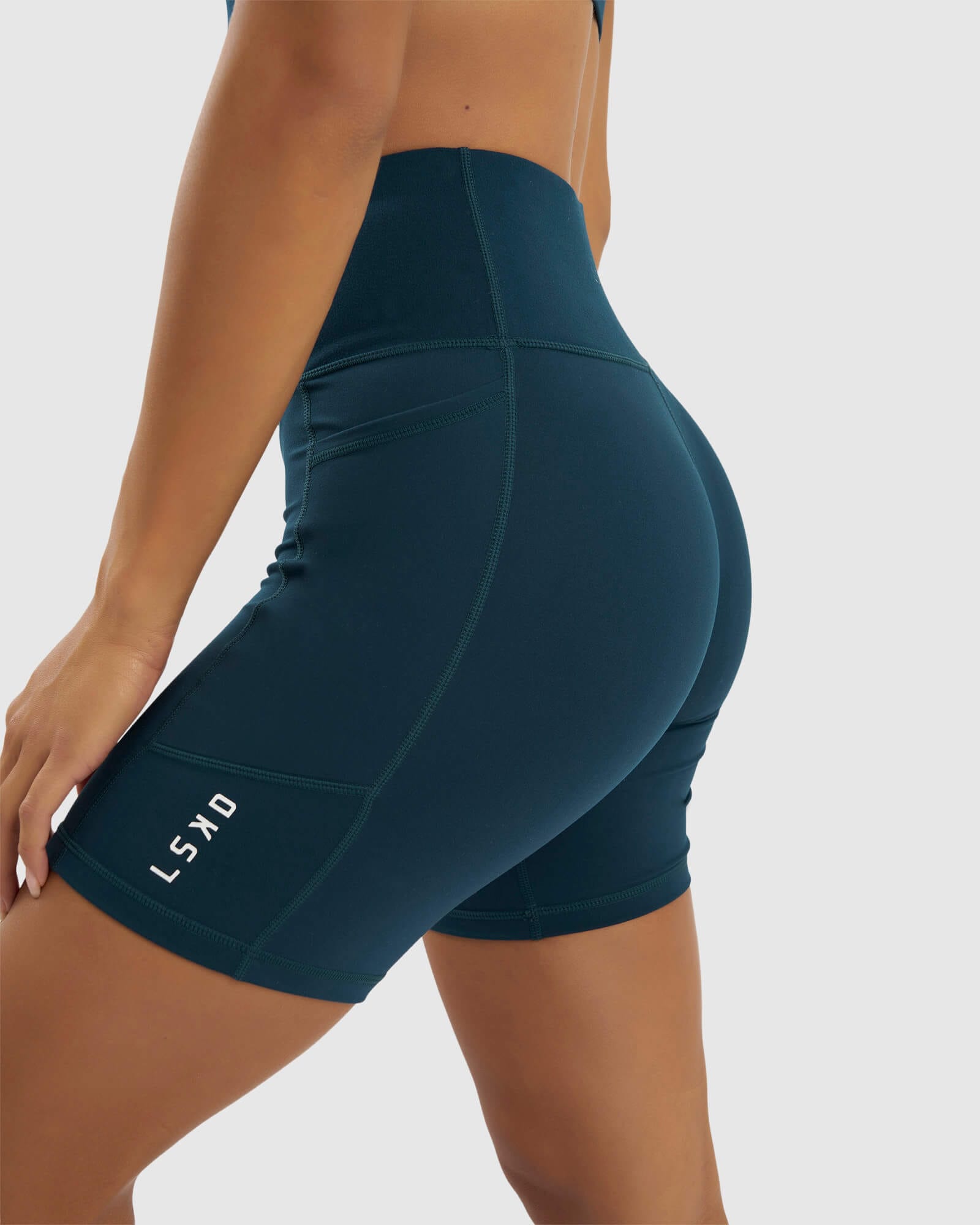 Model wearing Rep Mid Short Tight Small Logo - Deep Teal