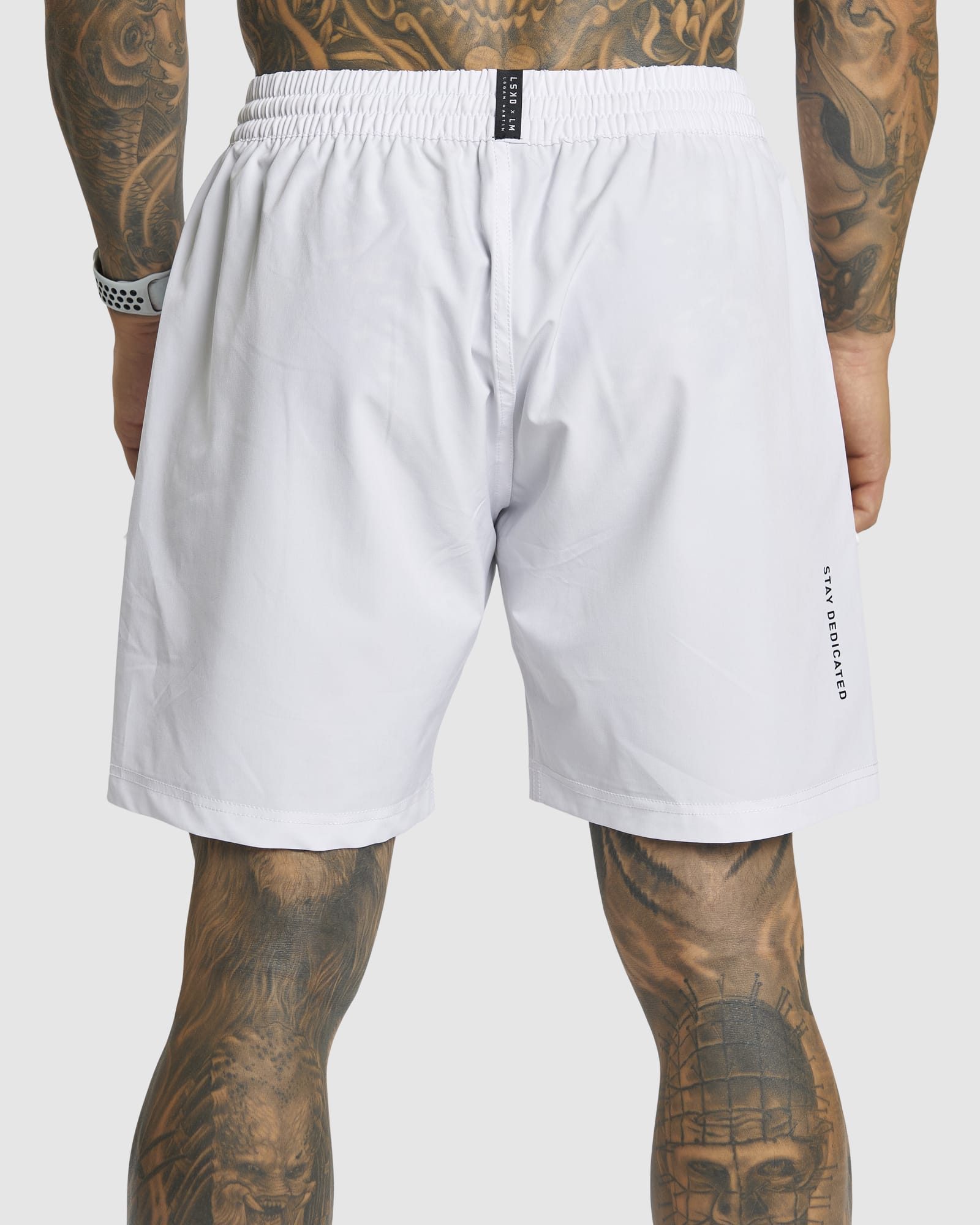 Model wearing LSKD x LM Rep 7" Performance Shorts - White