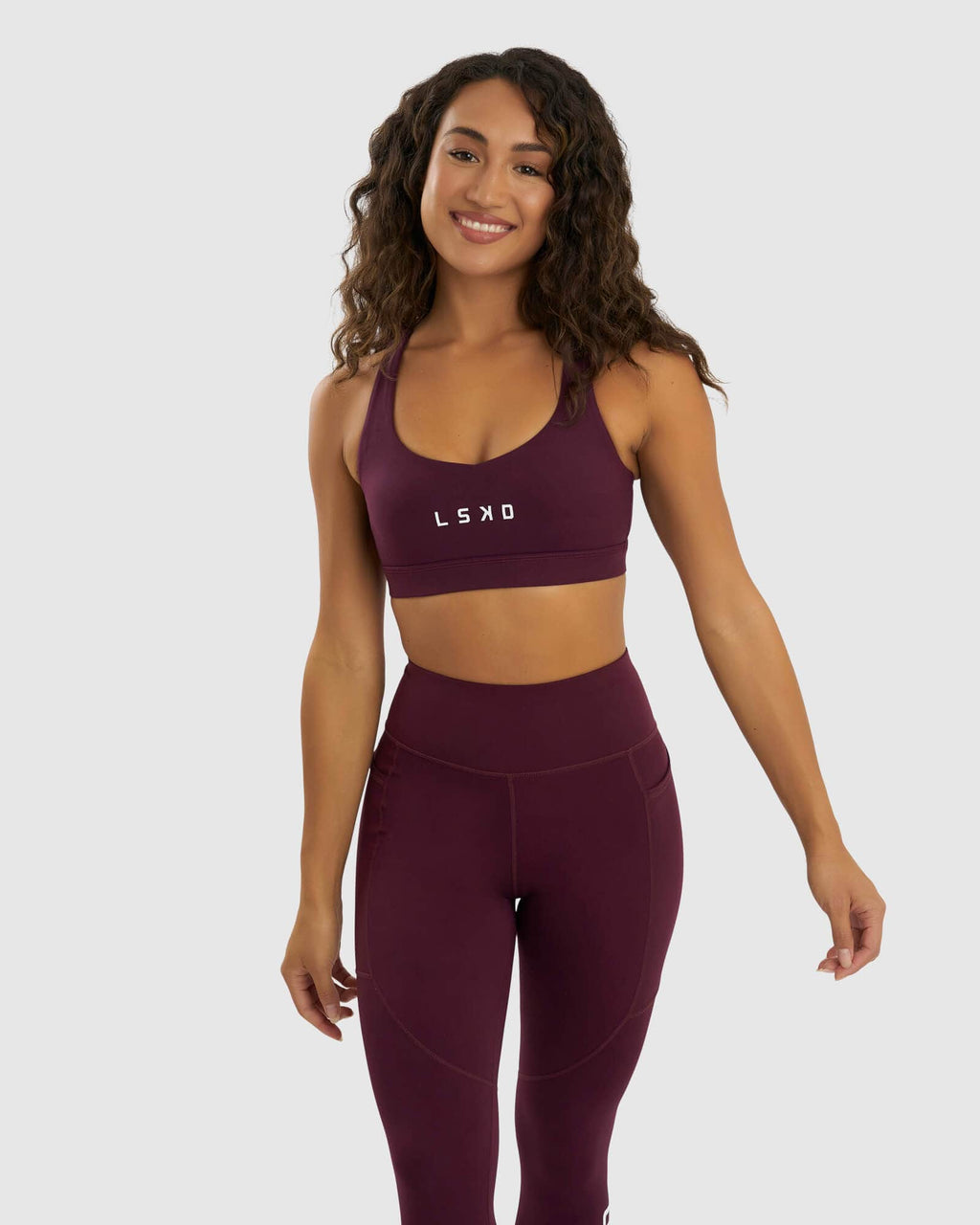 Model wearing Rep Sports Bra Small Logo - Wine