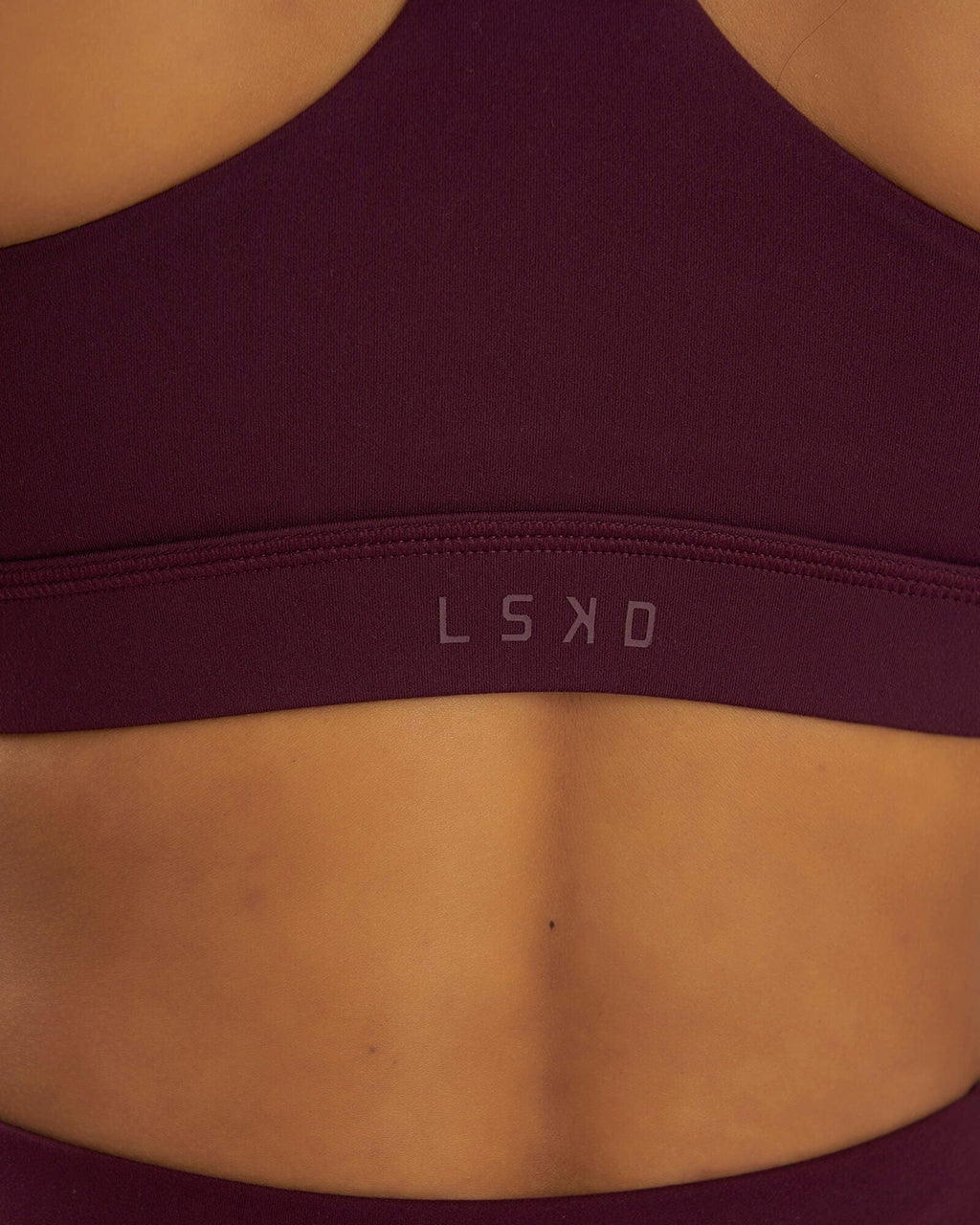 Model wearing Rep Sports Bra Small Logo - Wine