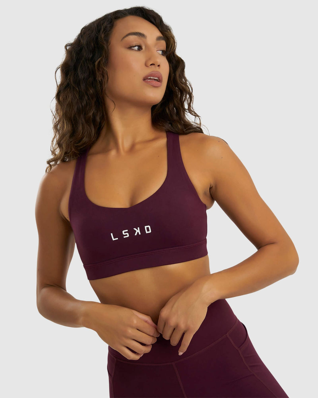 Model wearing Rep Sports Bra Small Logo - Wine
