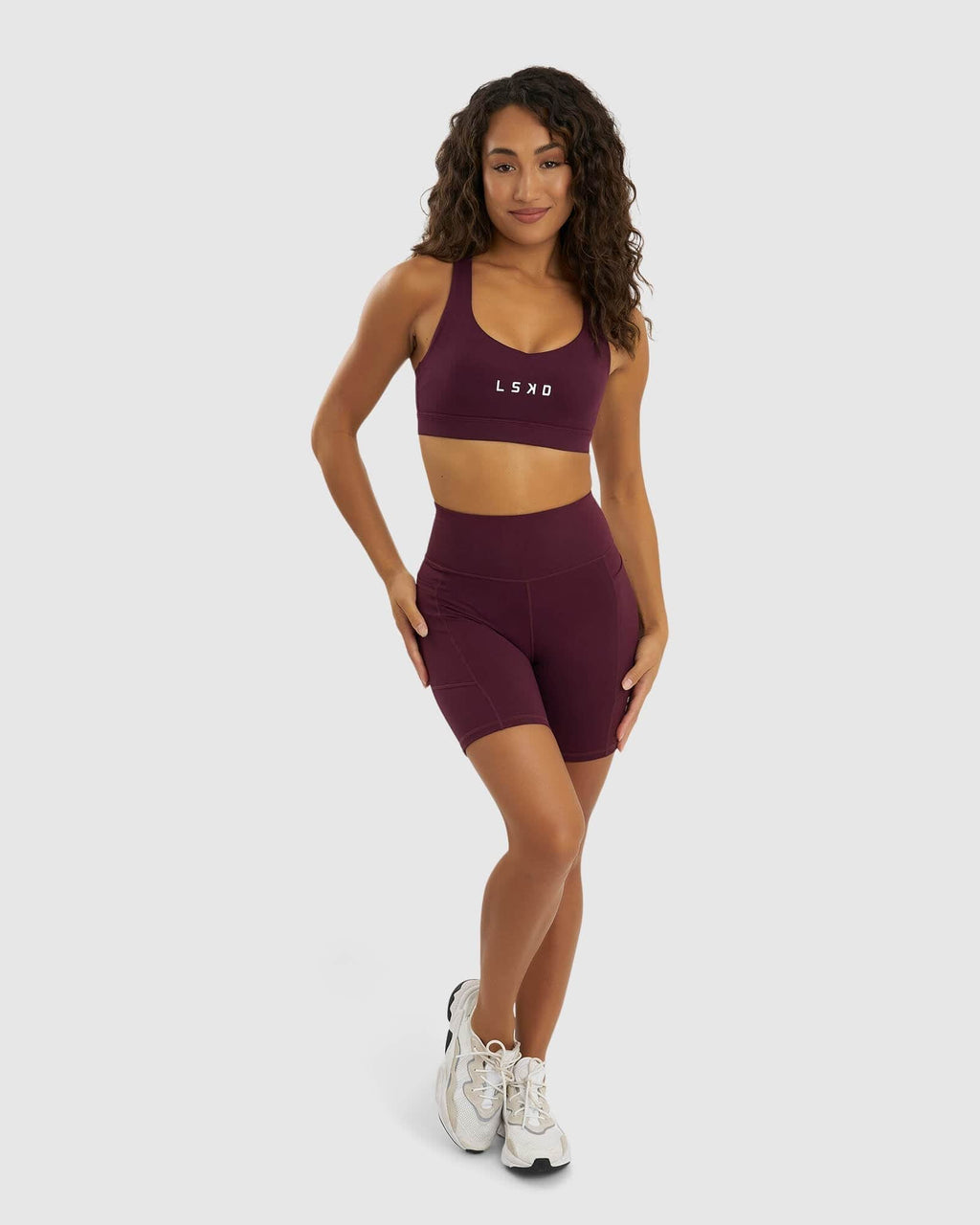 Model wearing Rep Mid Short Tight Small Logo - Wine