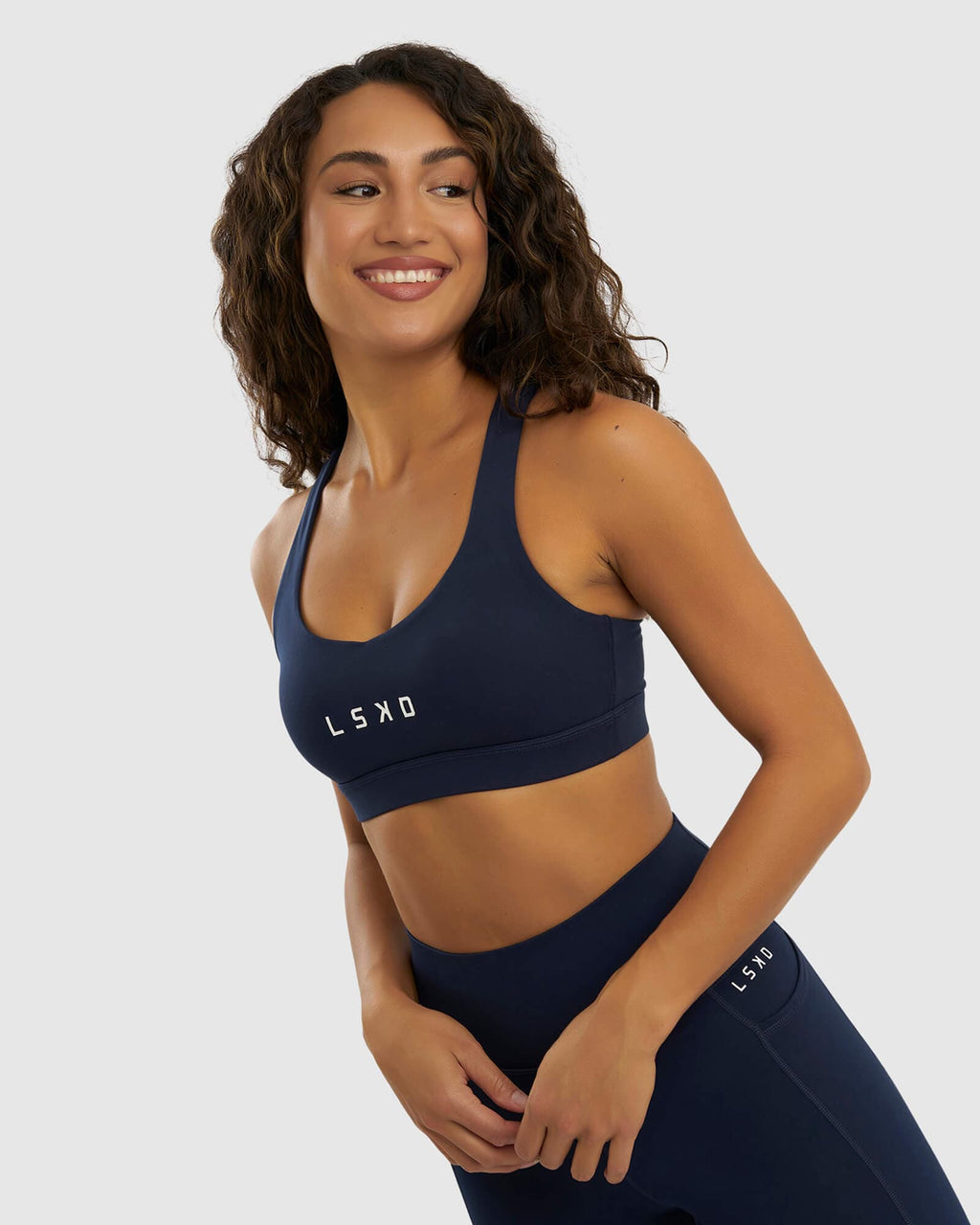 Model wearing Rep Sports Bra Small Logo - Navy
