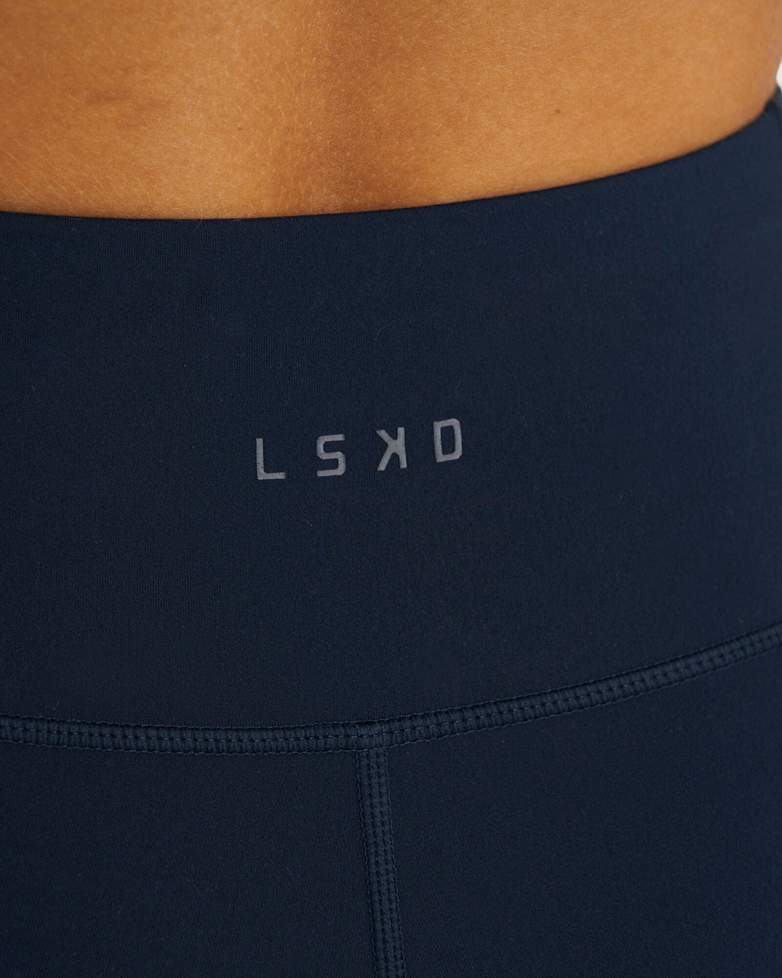 Model wearing Rep Mid Short Tight Small Logo - Carbon