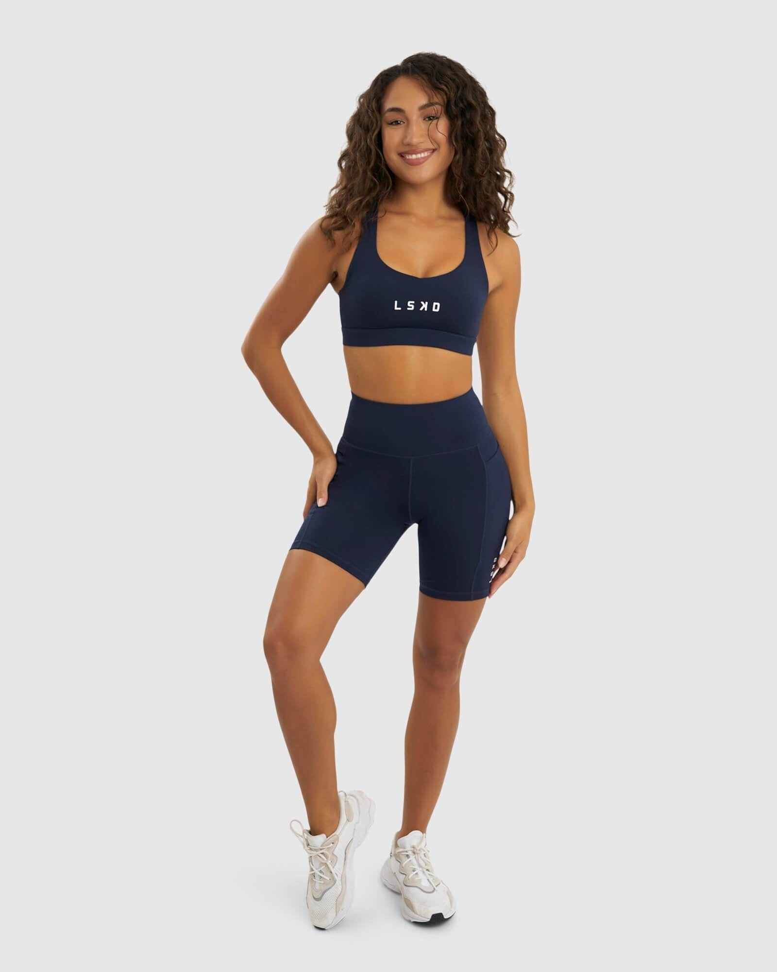 Model wearing Rep Mid Short Tight Small Logo - Navy