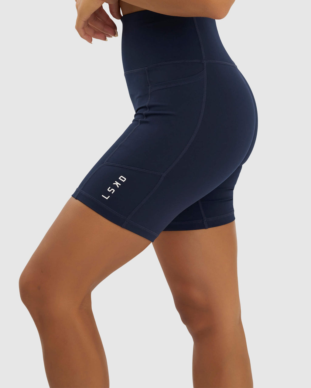 Model wearing Rep Mid Short Tight Small Logo - Navy